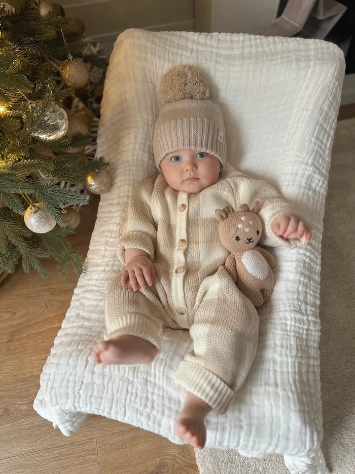 Neutral organic cotton baby romper for boys and girls.