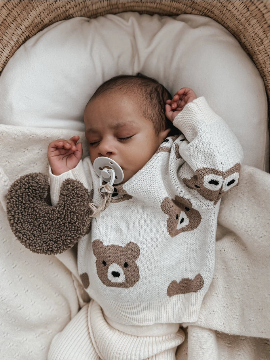 Cozy neutral baby sweater featuring all-over teddy bears.