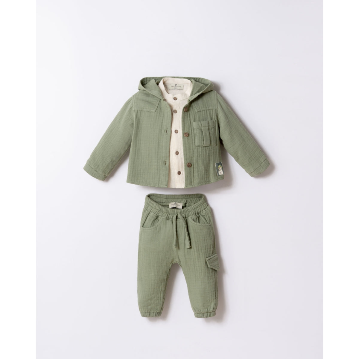 Three-piece green cotton baby set with drawstring pants and wooden buttons.