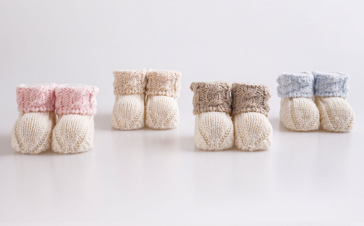Handmade knit baby booties, soft newborn shoes crafted from cozy cotton yarn
