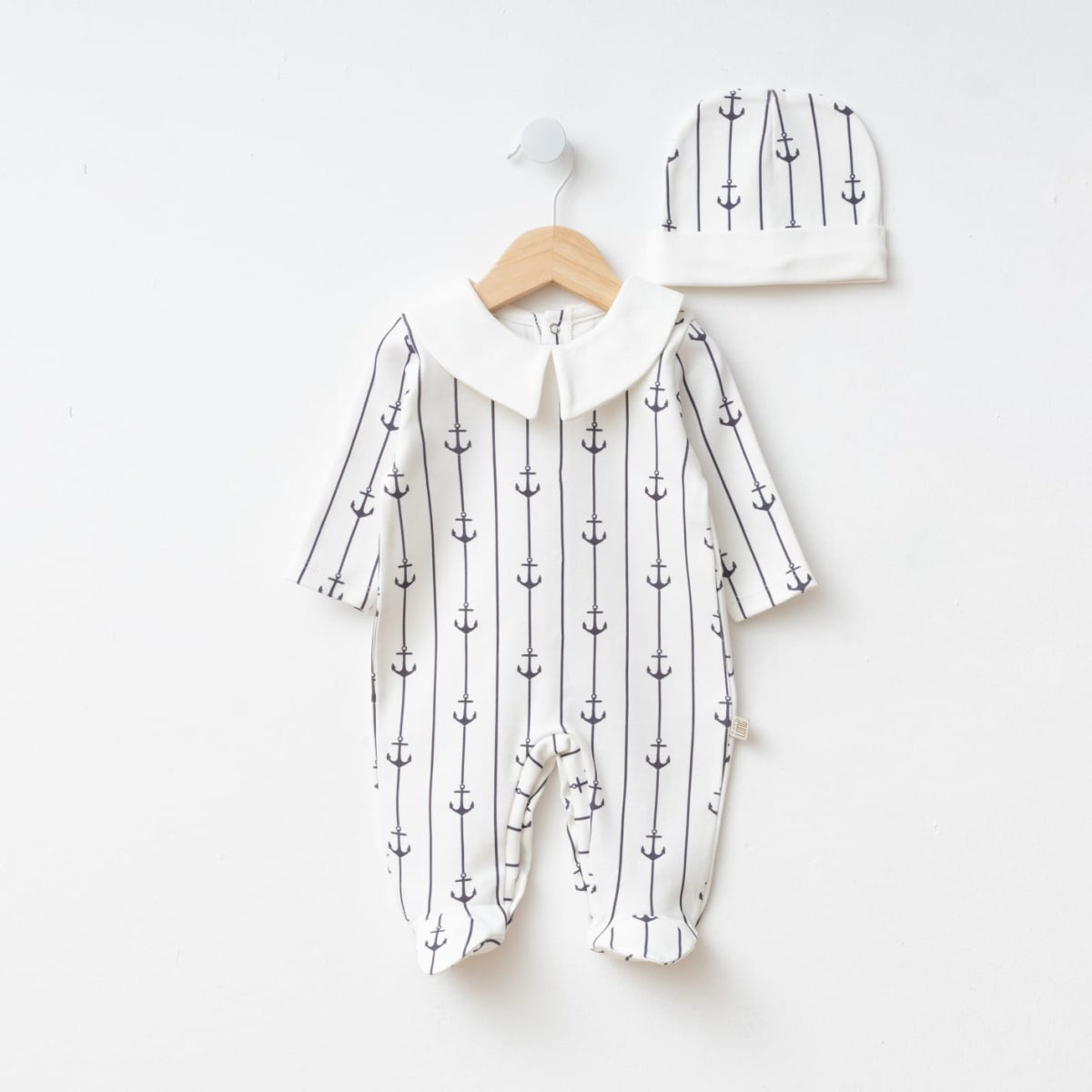 White baby romper with navy anchor print and matching hat