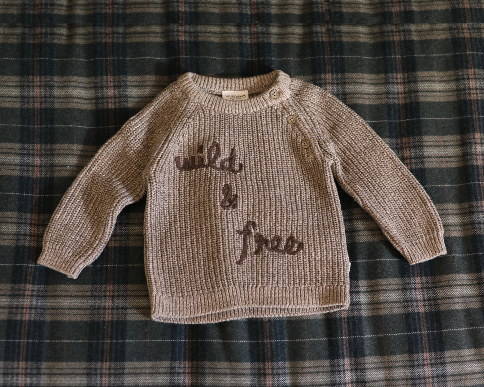 Cozy organic cotton infant sweater with shoulder button closure.