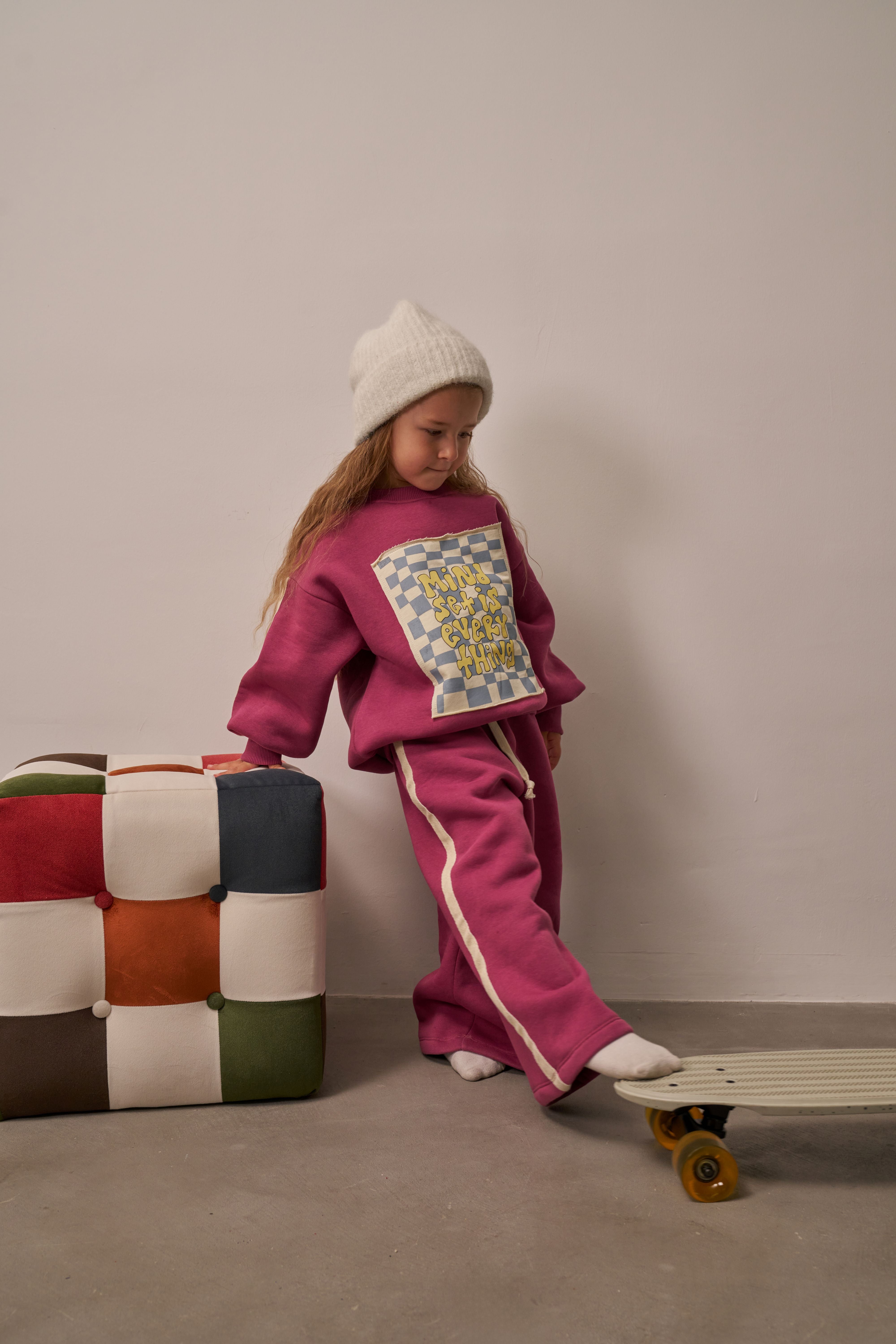 Girl wearing magenta tracksuit with ‘Mindset is Everything’ print