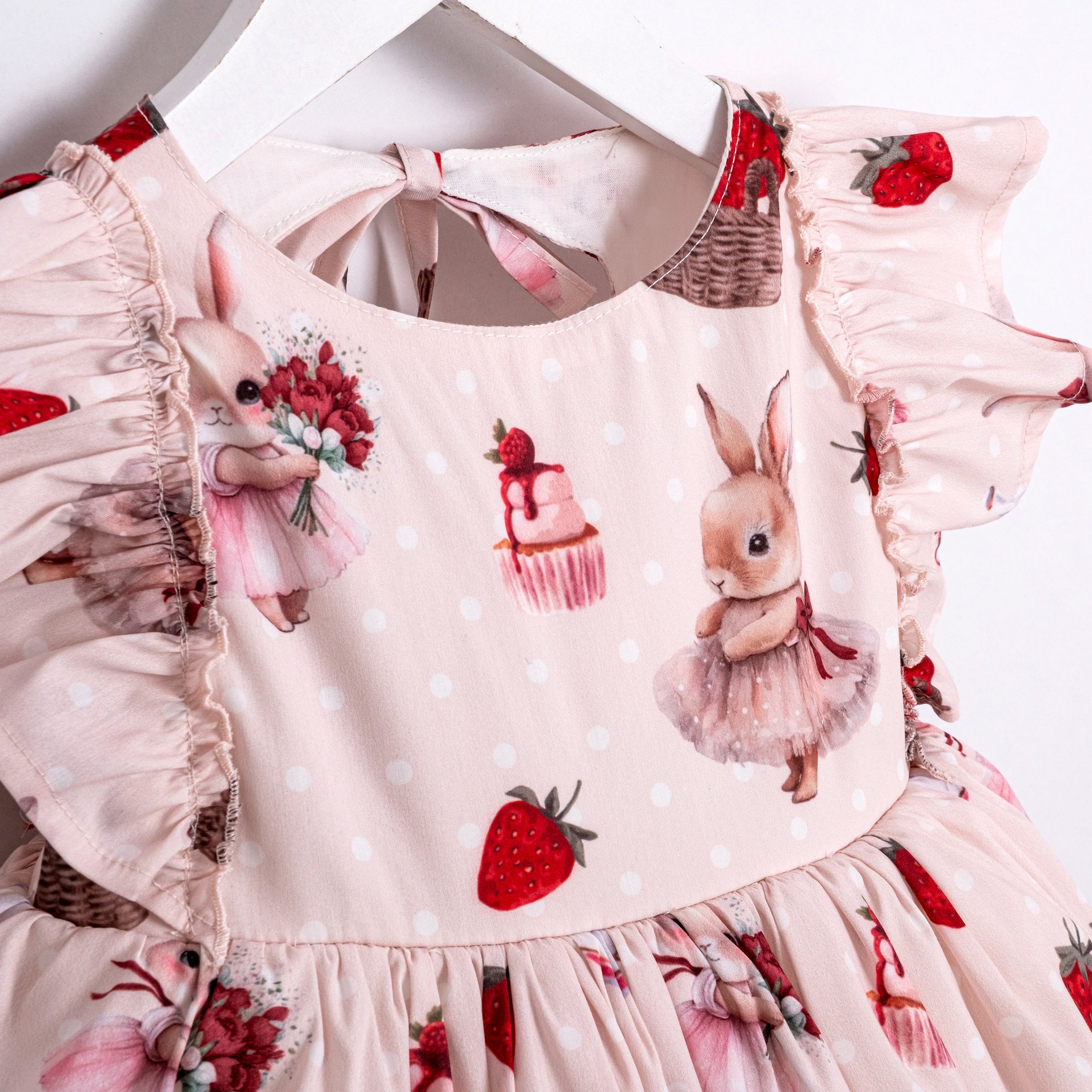 Toddler dress with ruffle sleeves and strawberry bunny pattern