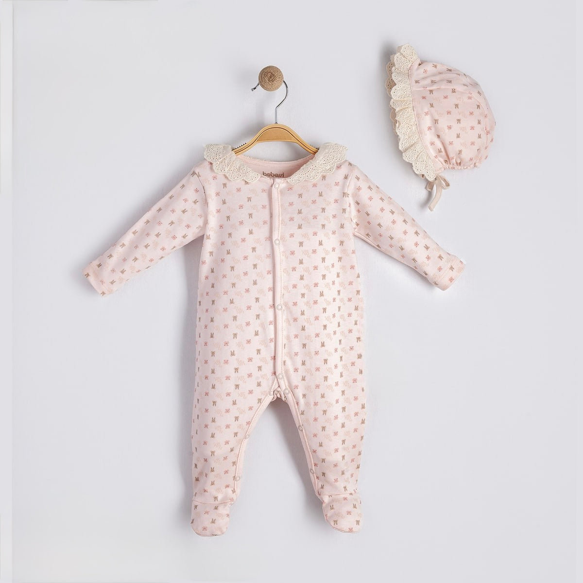 Blush newborn footie with lace collar and matching bonnet