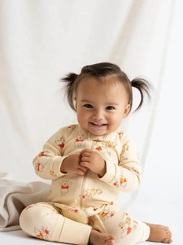 Baby wearing Disney Winnie the Pooh organic cotton zip sleeper with breathable fabric.