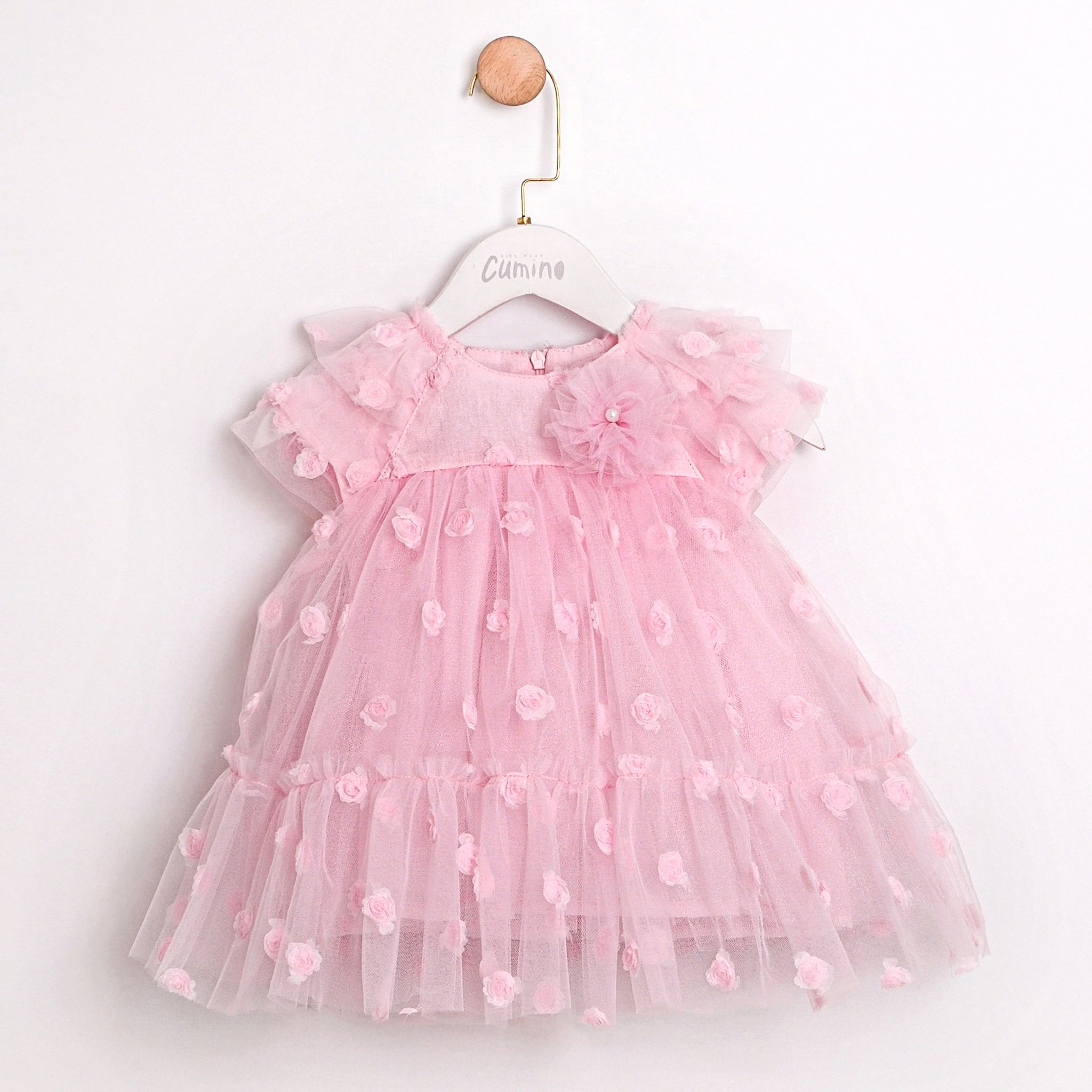 Aurora pink baby dress with layered tulle and delicate flower details.