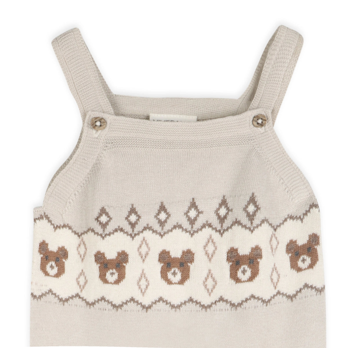 Beige knit baby overalls with a repeating brown teddy bear design and geometric accents