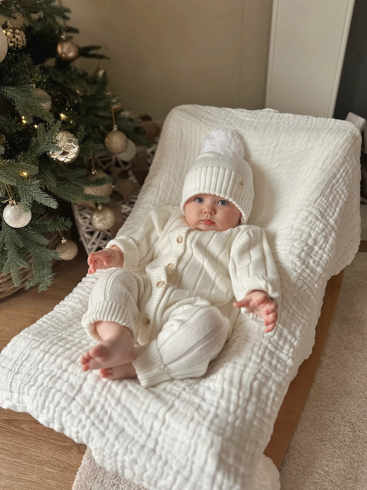 Organic cotton knit baby jumpsuit with wooden button front.