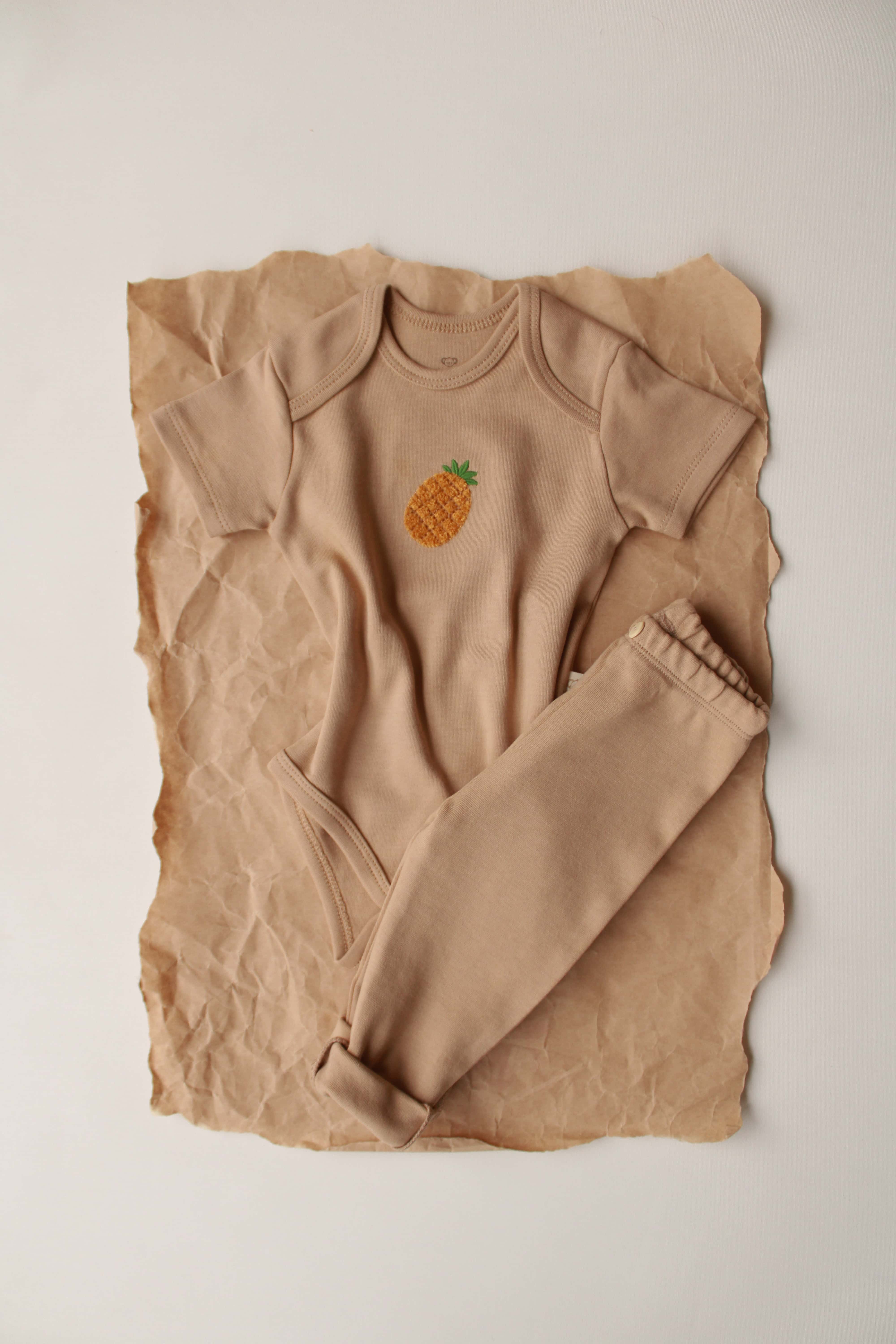 Pineapple patterned short sleeve baby top and pant set, soft cotton outfit for infants.