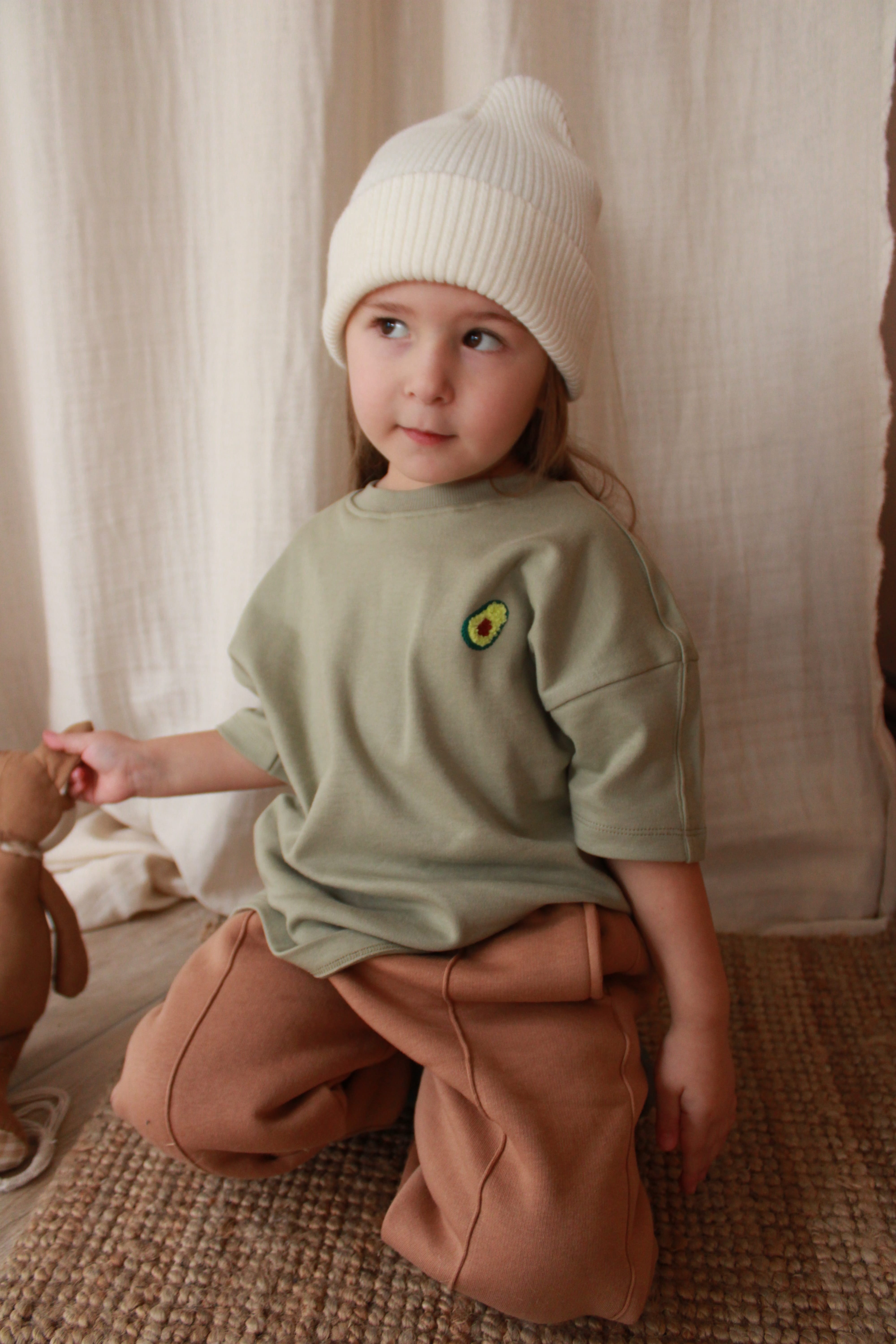 Unisex oversize avocado baby t-shirt, soft cotton clothing perfect for infants and toddlers.