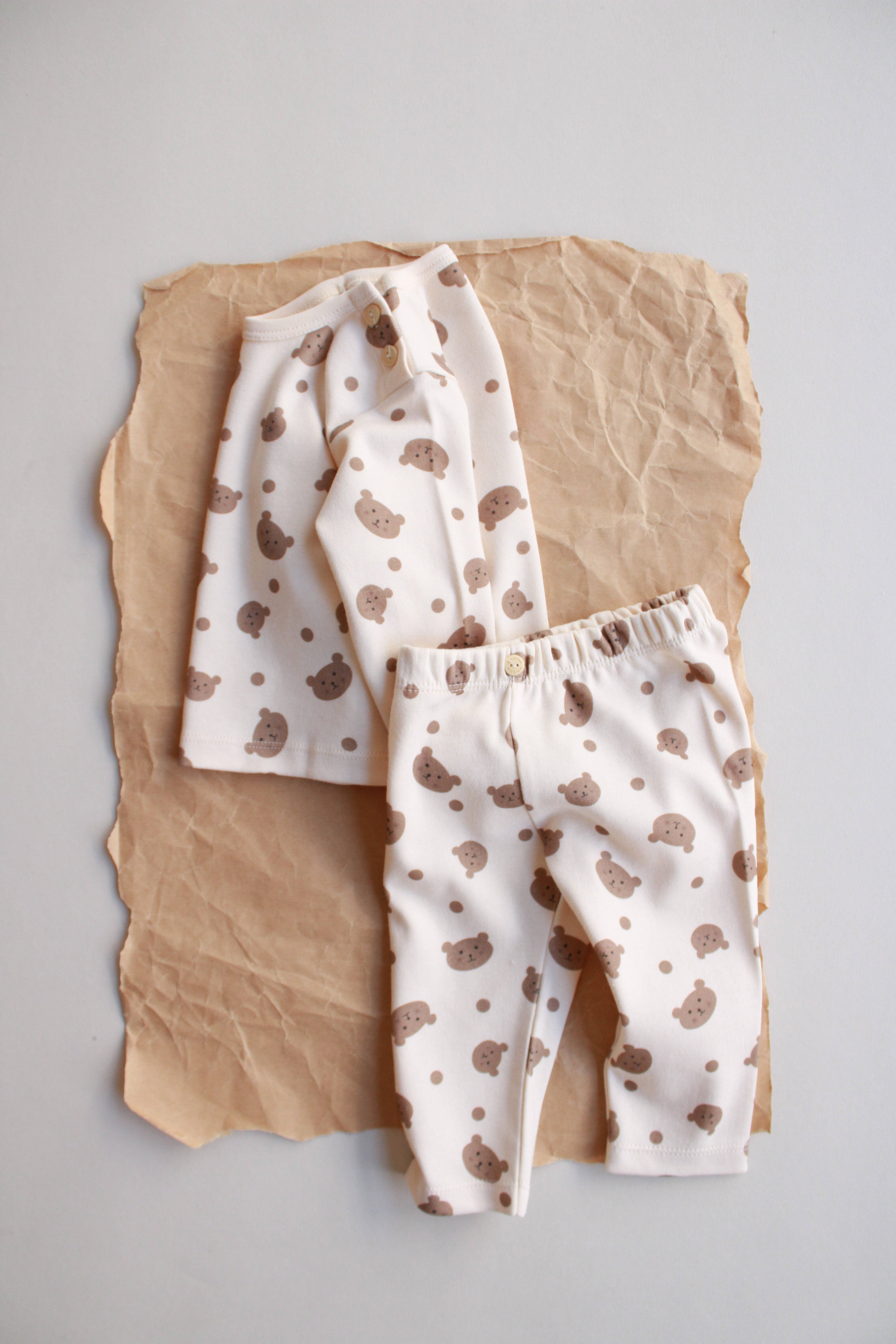 Two-piece baby set featuring teddy bear print top and soft cotton bottoms.