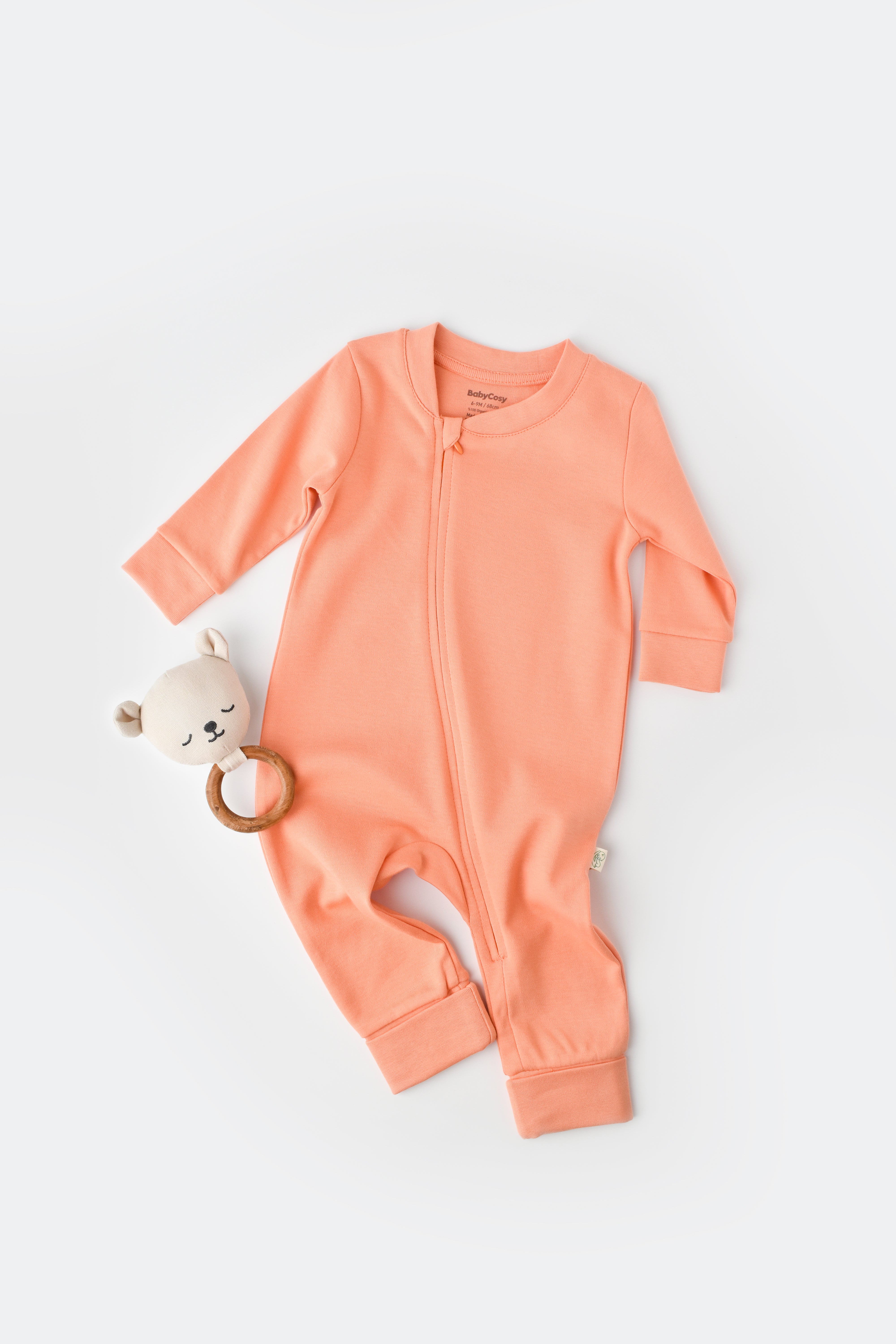 Salmon color baby onesie made from 100% organic cotton, soft and breathable outfit.