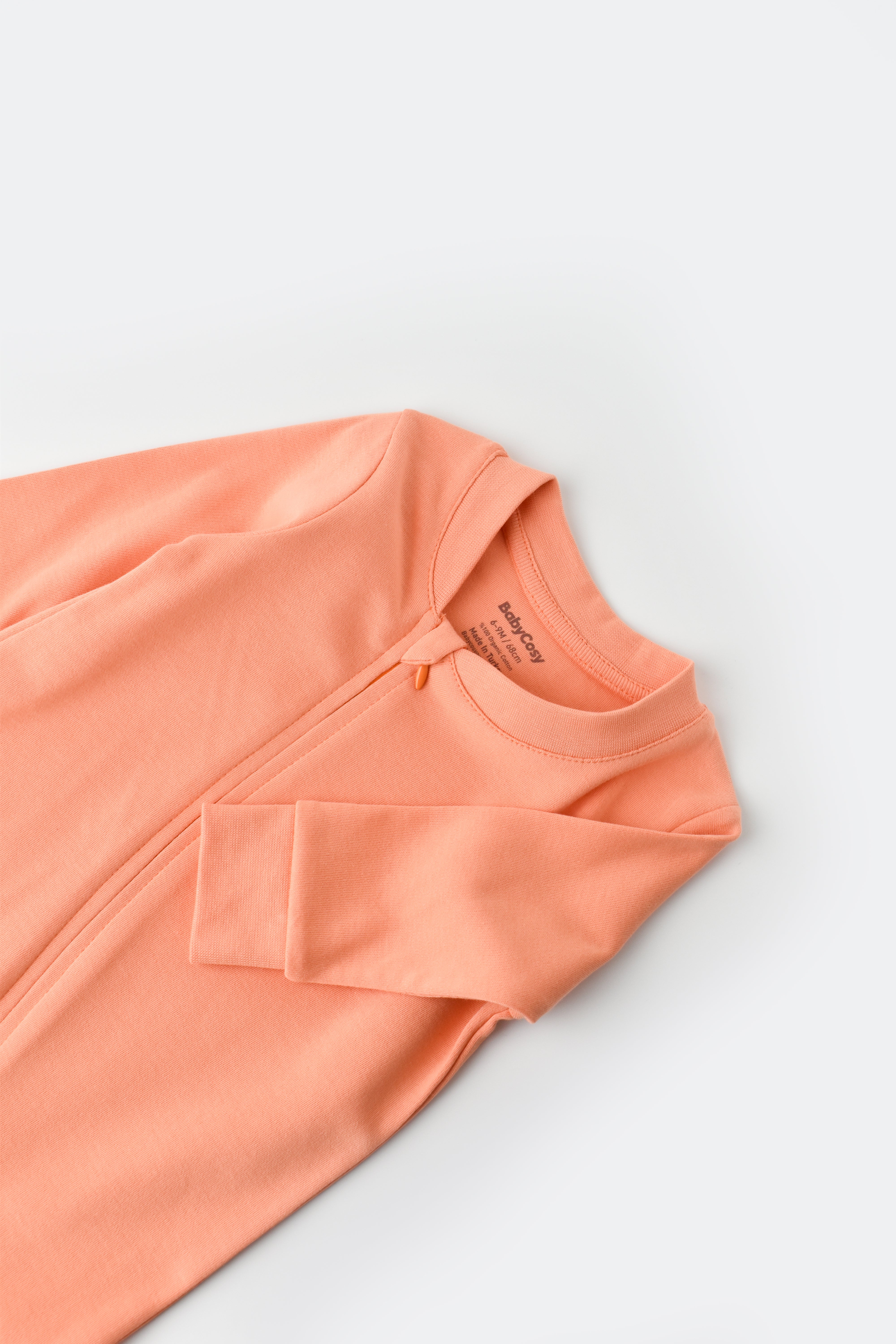 Unisex salmon organic cotton baby onesie, cozy and eco-friendly clothing for newborns.