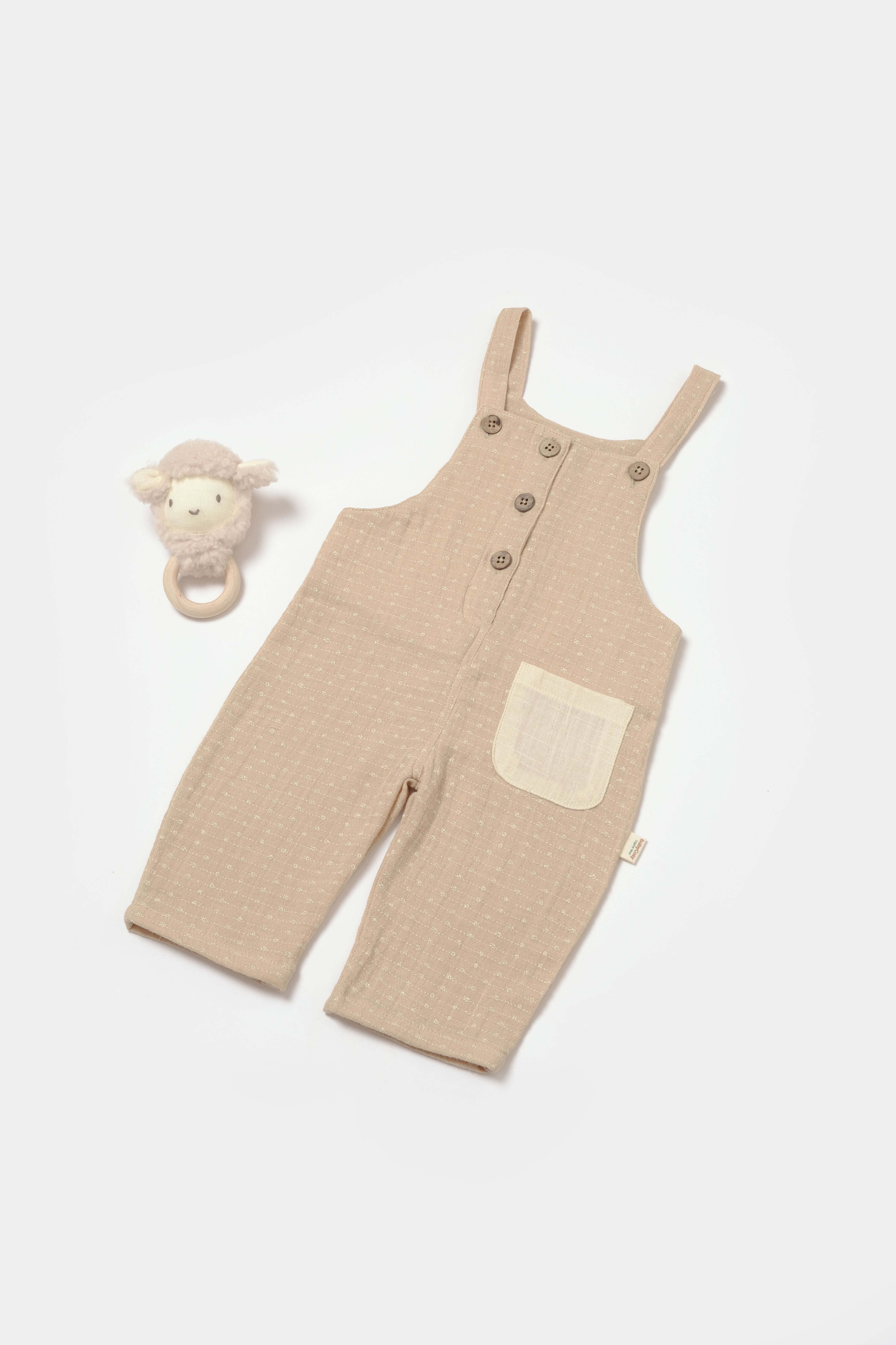 Beige muslin baby romper with front buttons and pocket