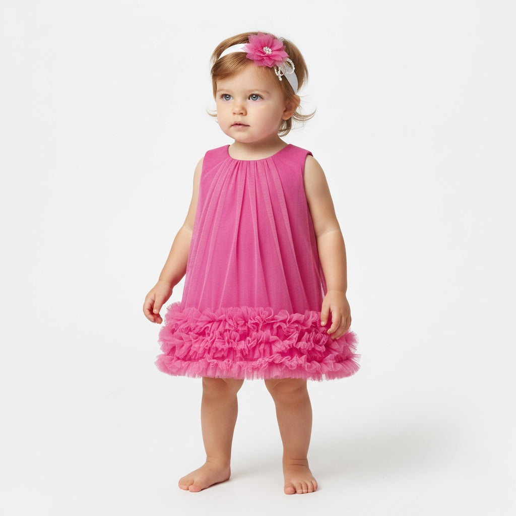 Fuchsia tulle baby dress with ruffled hem and pearl-accented headband.