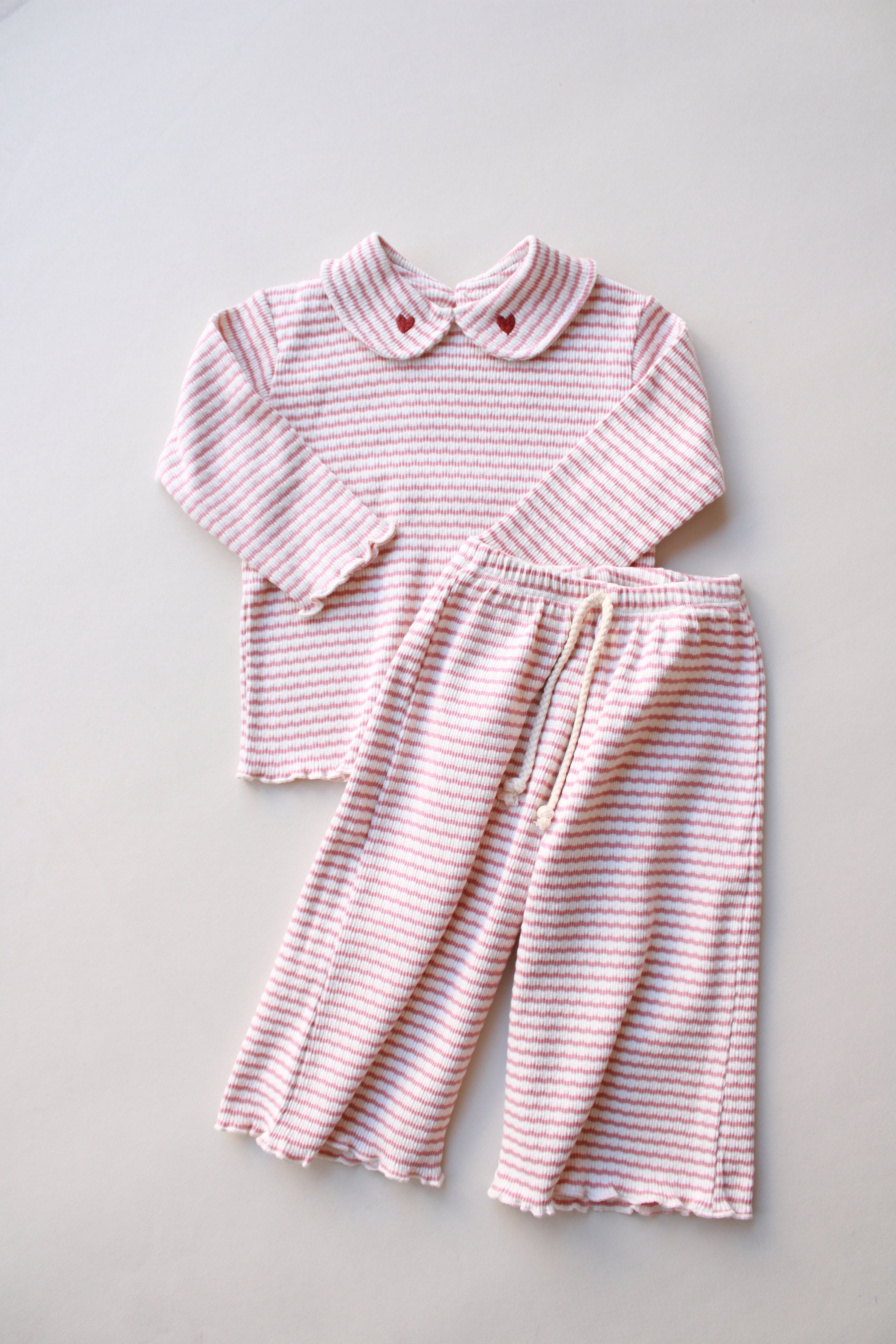 Pink striped baby outfit with heart-detailed collar and matching pants.