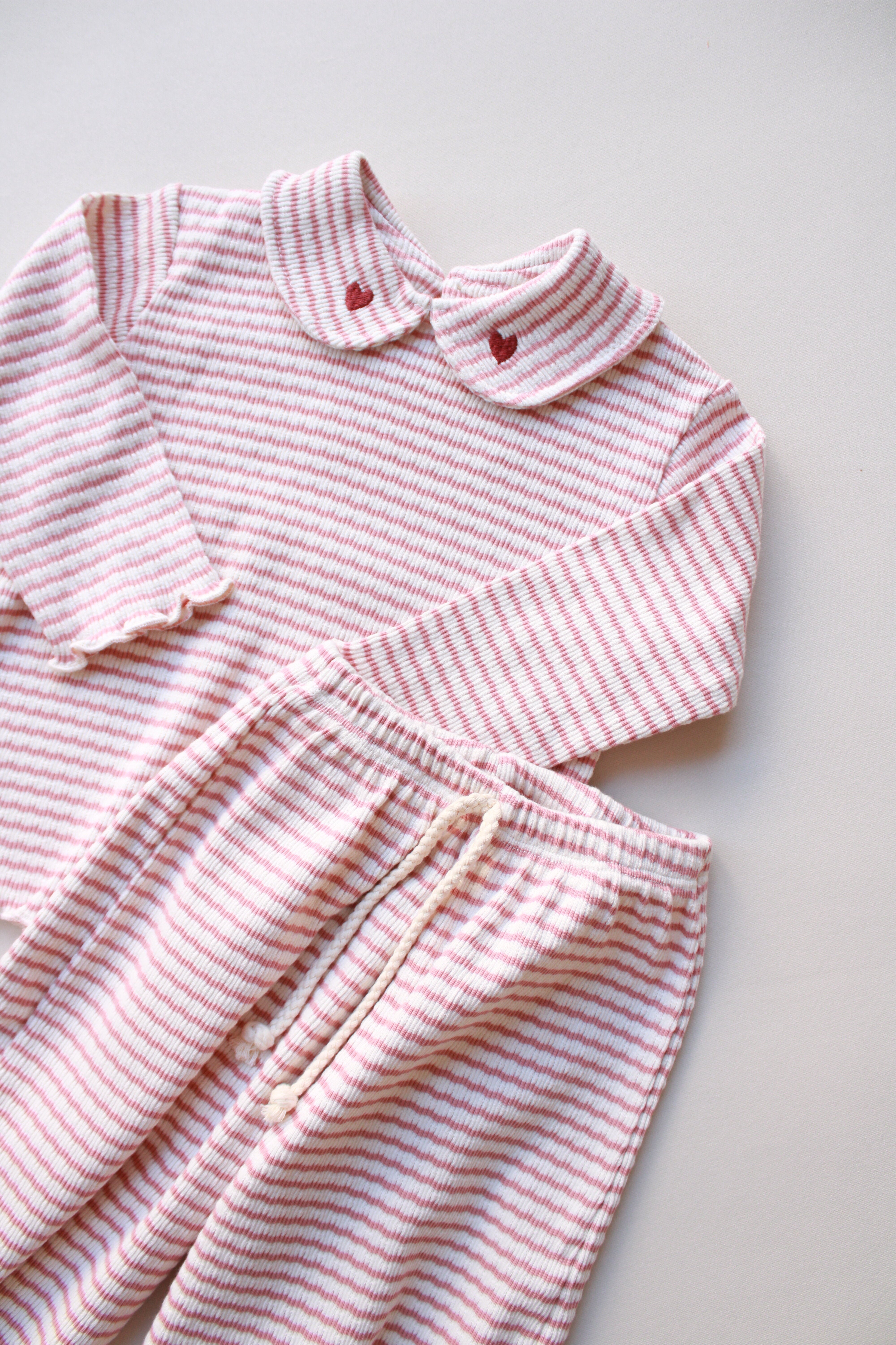 Soft ribbed cotton baby outfit featuring heart collar top and drawstring pants