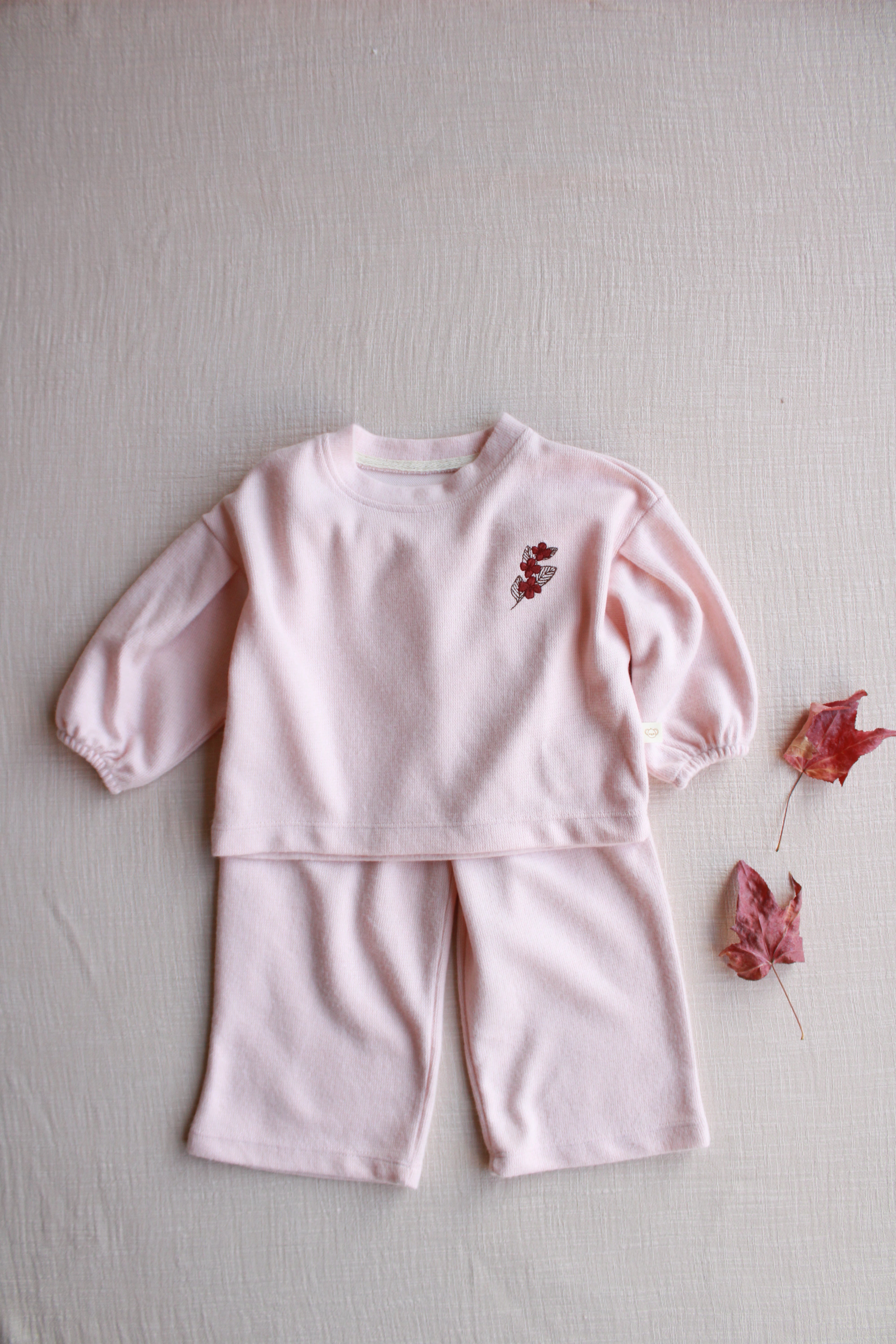 Soft pink baby lounge set with long sleeve top and relaxed fit pants