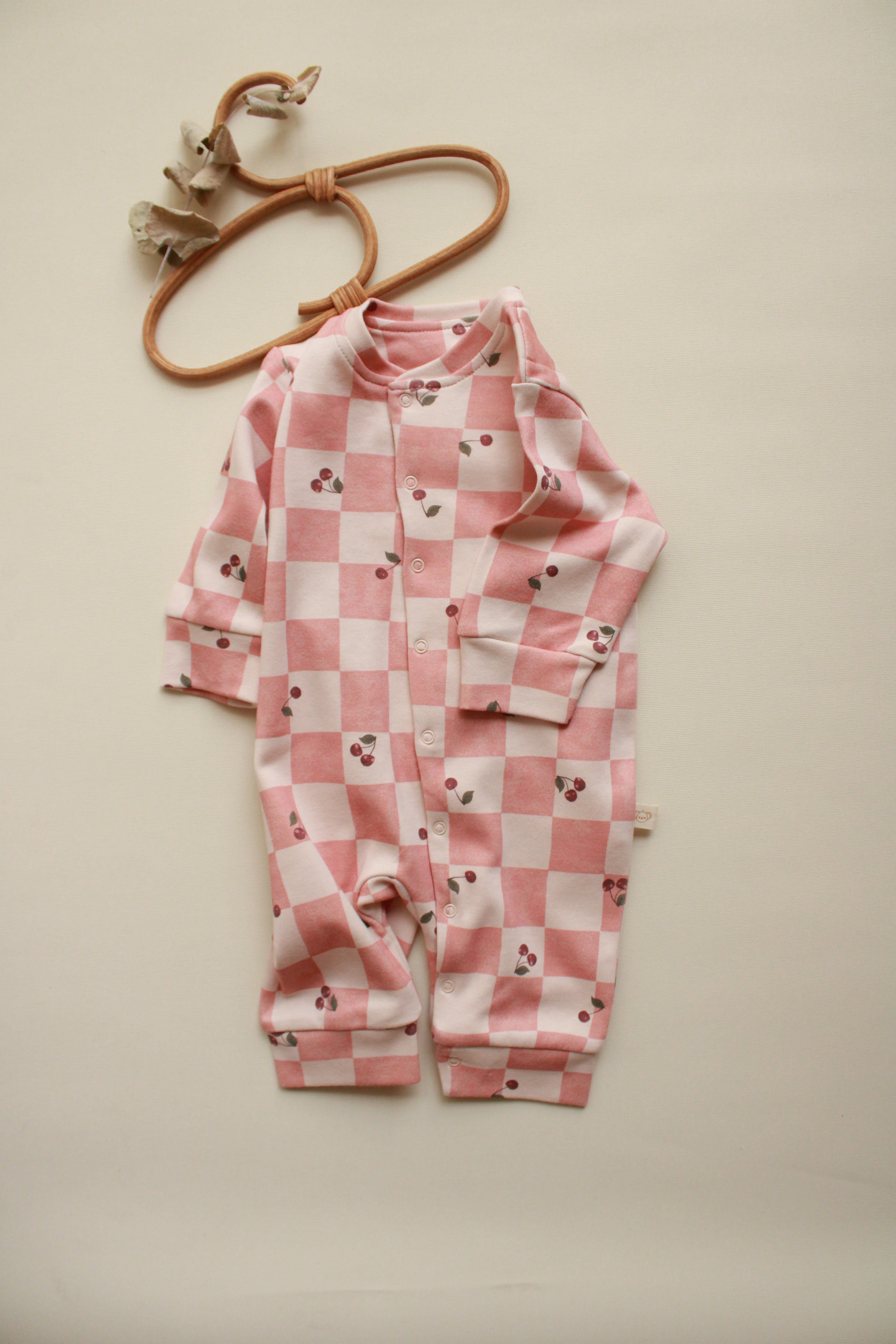 Long sleeve cherry plaid baby jumpsuit with snap closure