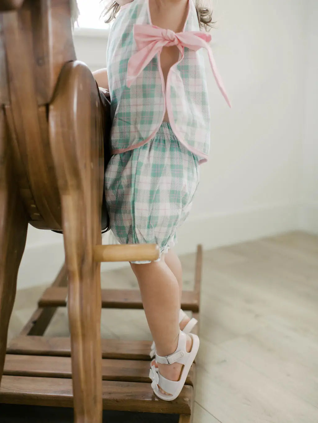 Toddler wearing mint plaid sleeveless top and matching bloomer shorts