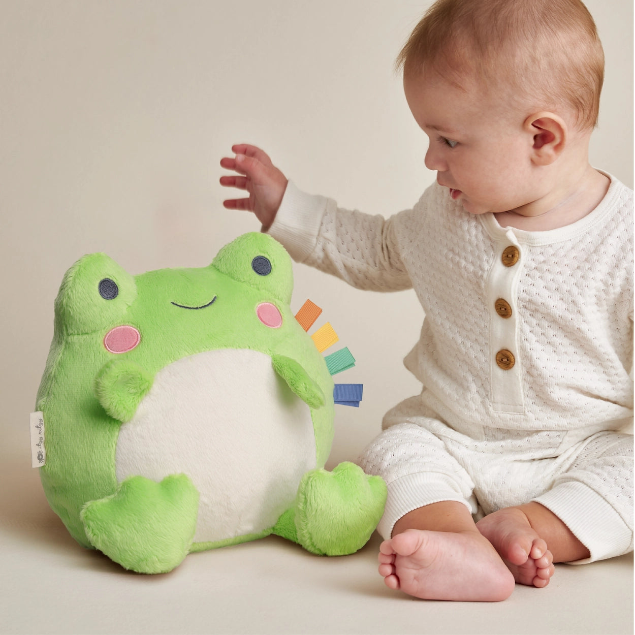 Green and cream stuffed frog baby toy