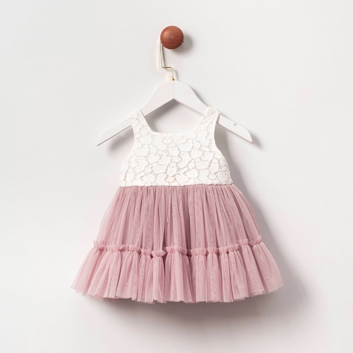Elegant blush baby dress with lace and tulle details, perfect for birthdays or christening.