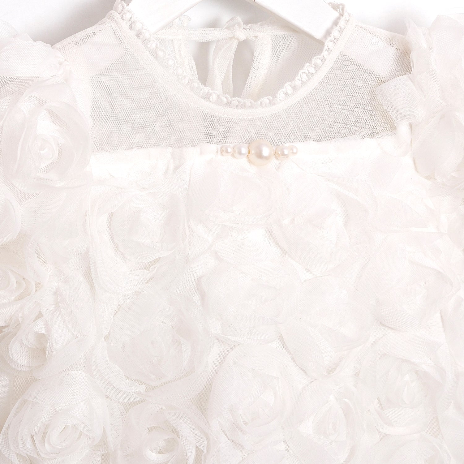 Organic cotton Pearl Rose white romper, cozy infant outfit ideal for newborn comfort.