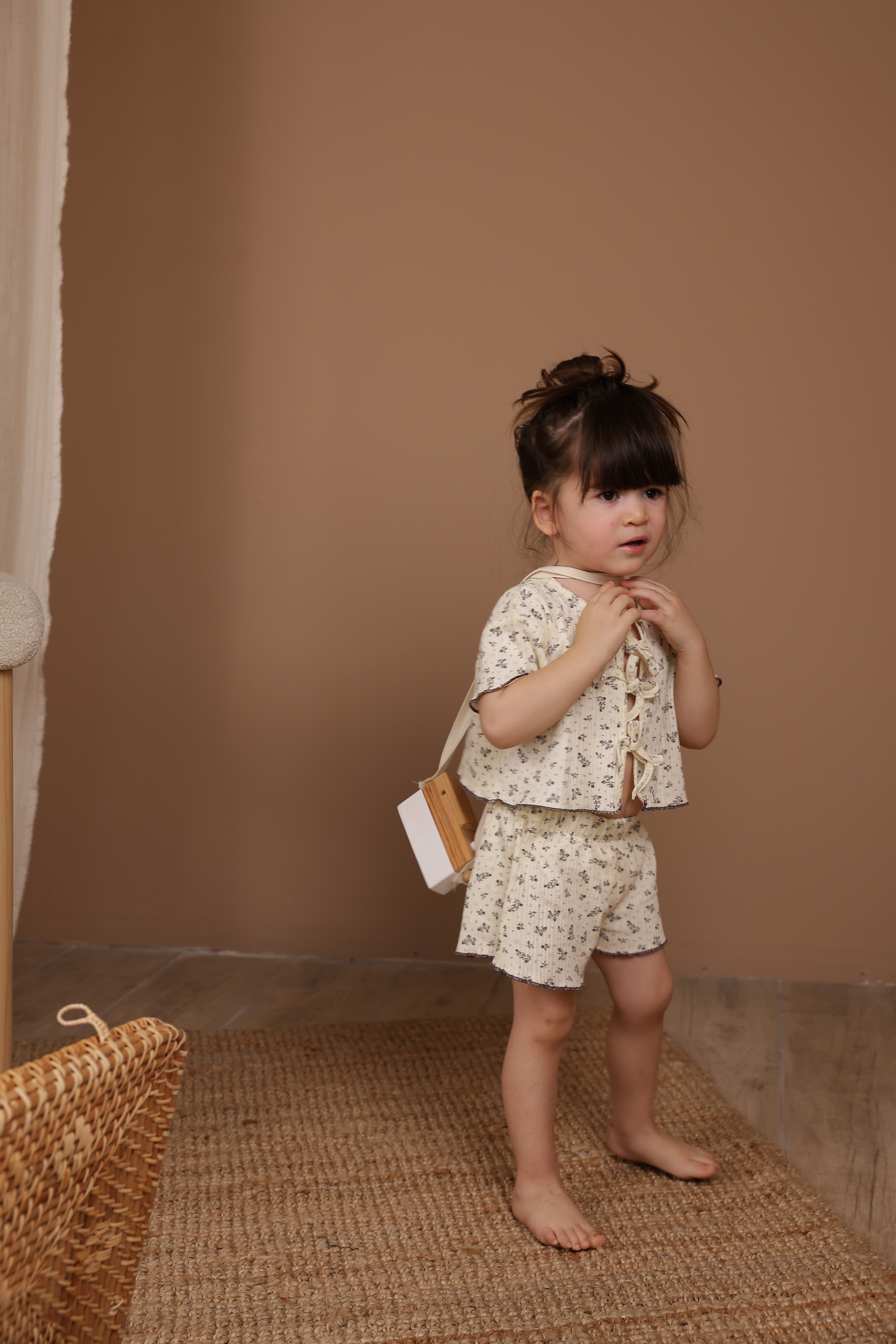 Adorable wildflower print tie-front baby set, breathable cotton outfit for infants and toddlers.