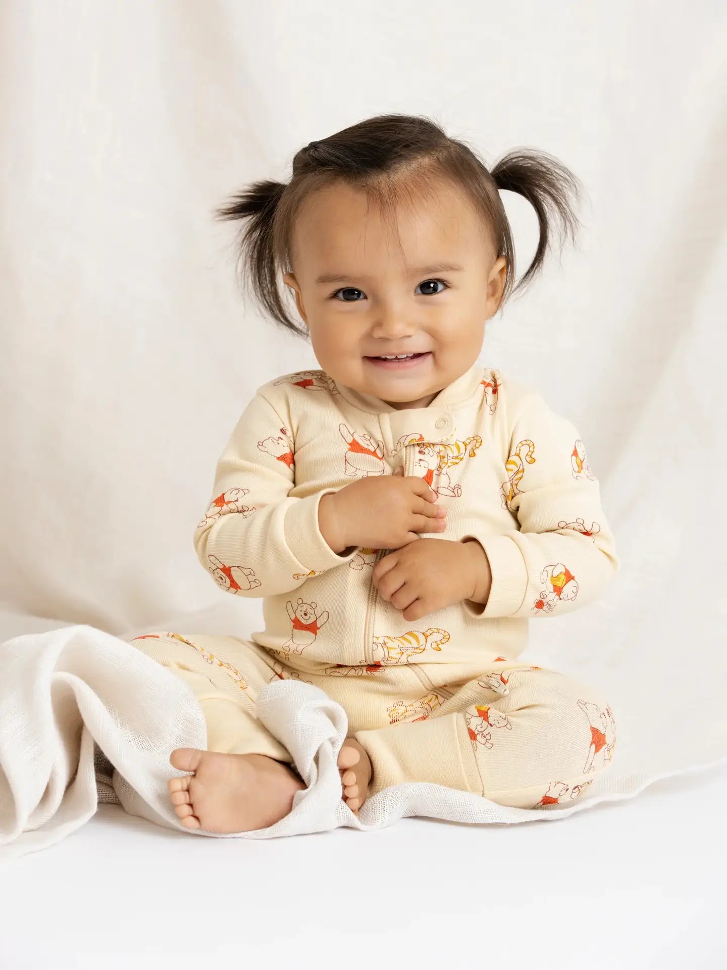 Long sleeve Disney baby pajamas with two-way zipper and organic cotton fabric.