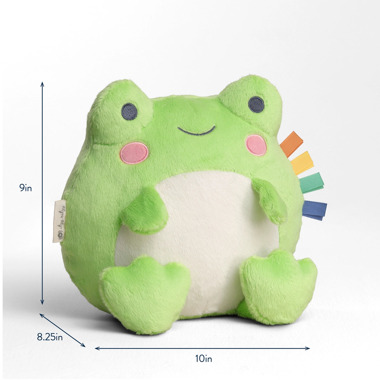 Baby playing with green frog plush toy