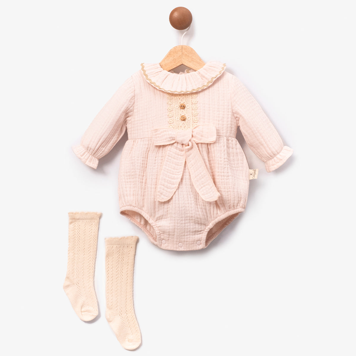 Elegant baby romper set in soft blush with lace trim and wooden buttons