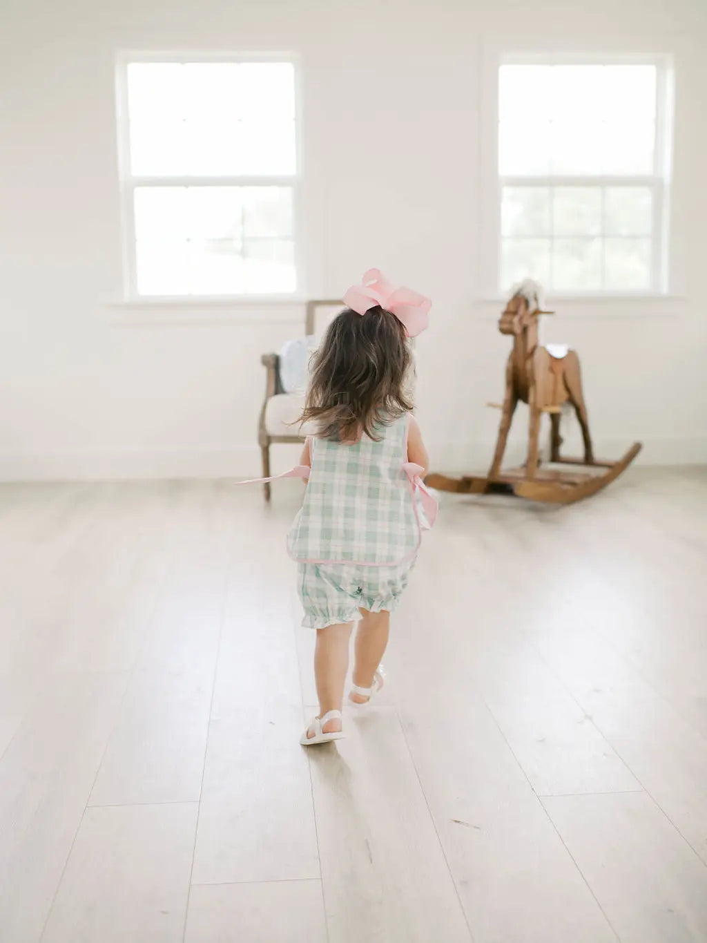 Back view of mint plaid girls set with pink bow details
