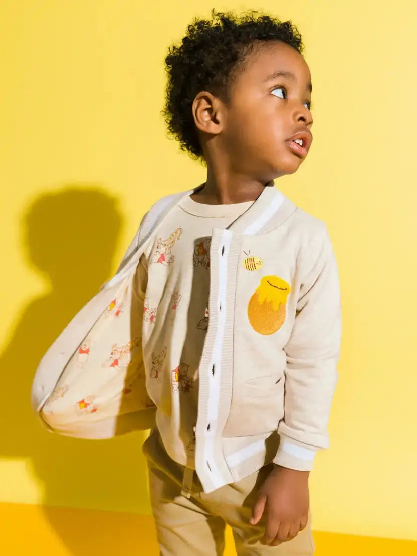 Baby and toddler organic bomber jacket featuring Winnie the Pooh, honey pot, and bee embroidery.