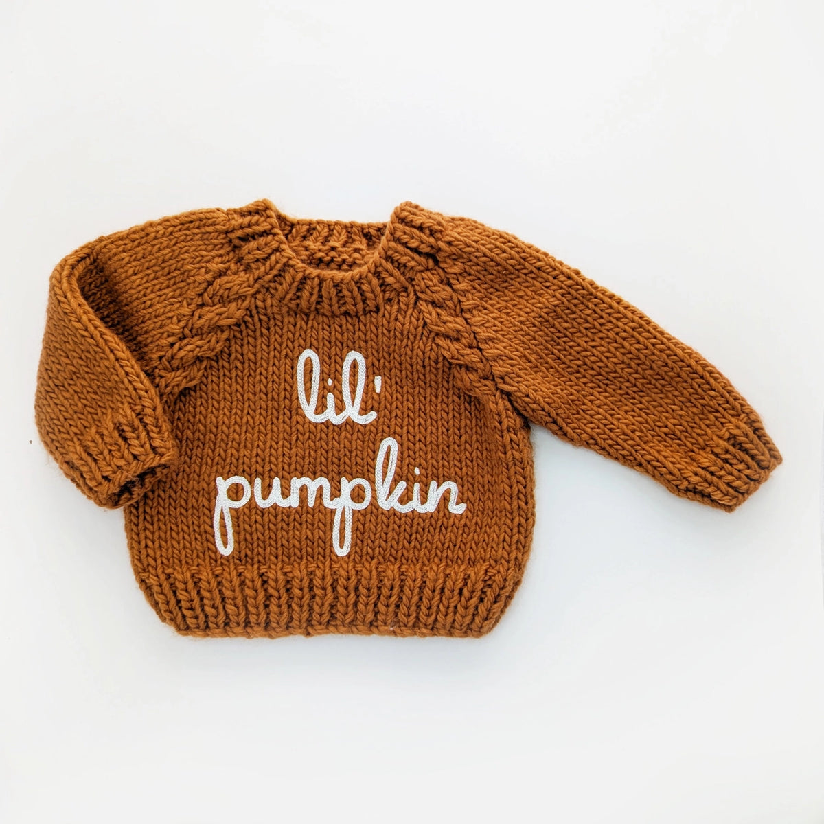 cozy orange knit baby sweater with lettering and cable knit detail
