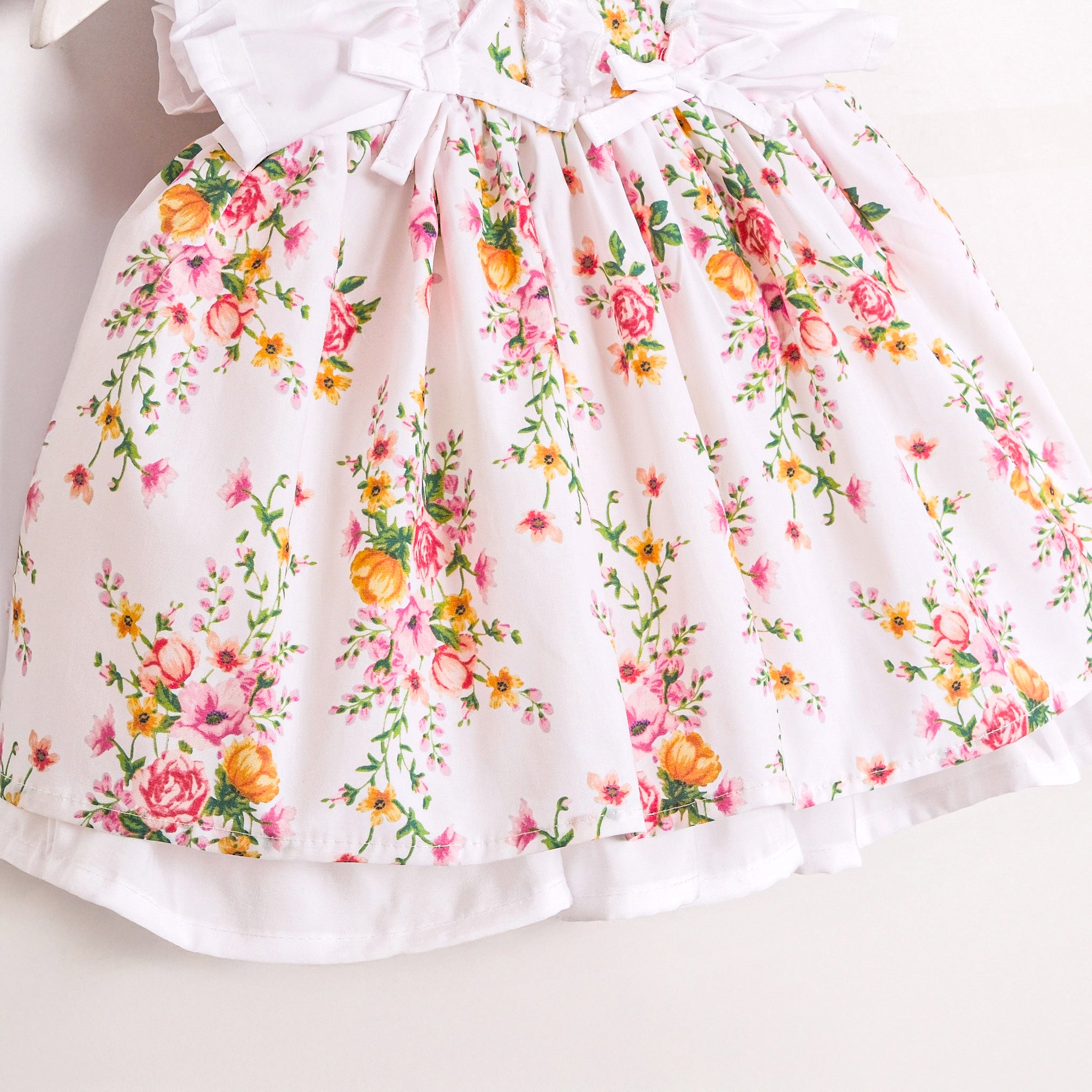 Spring baby dress with pink floral print and bows