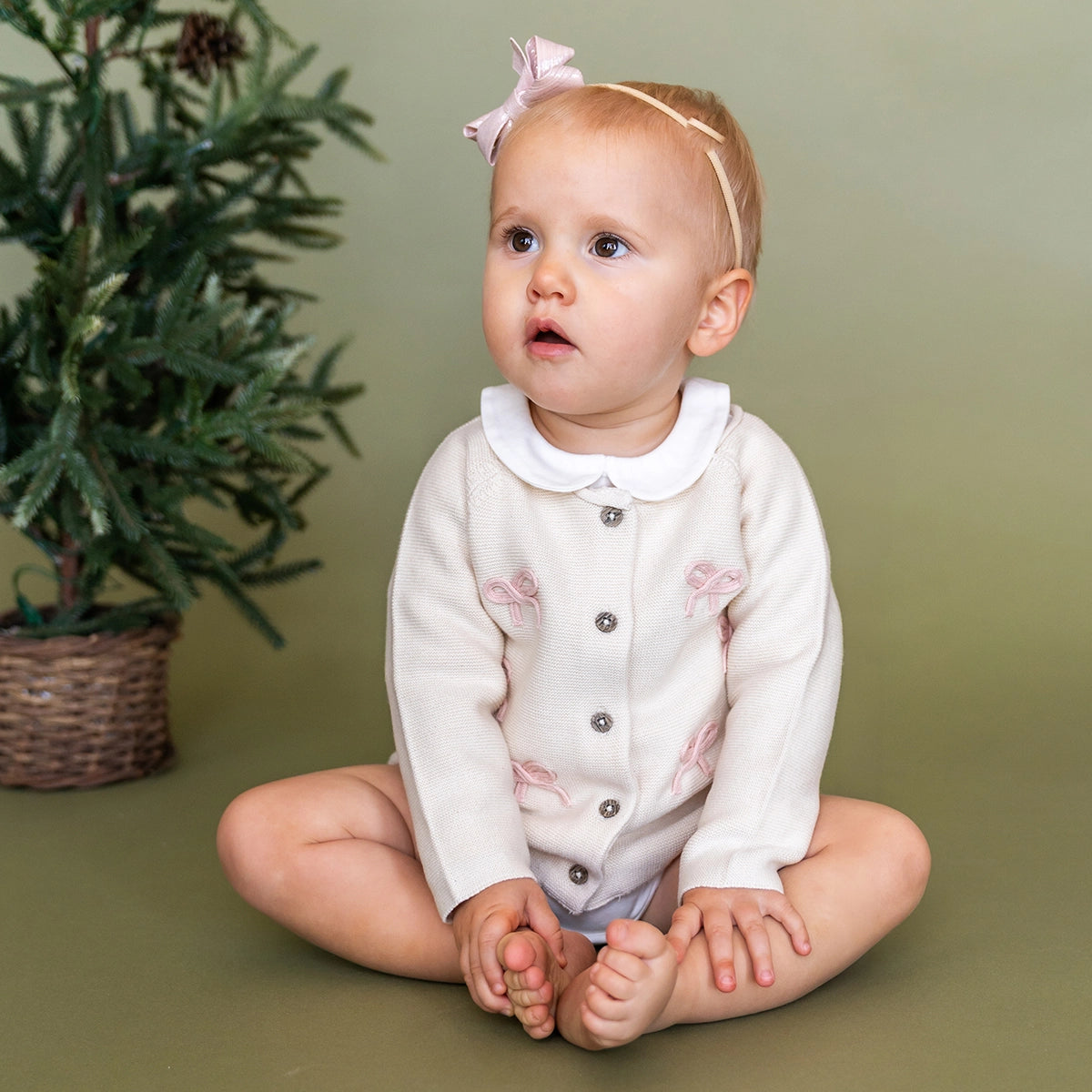 Organic cotton baby cardigan with embroidered bows and wooden buttons