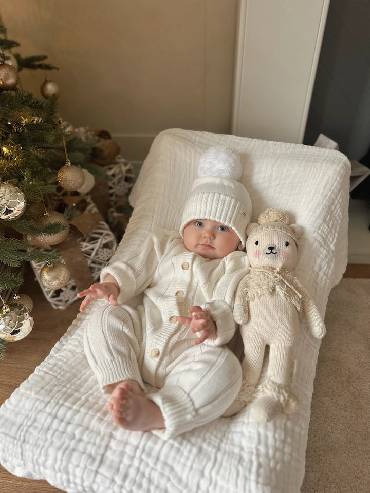 Neutral organic knit baby jumpsuit for newborns and infants.