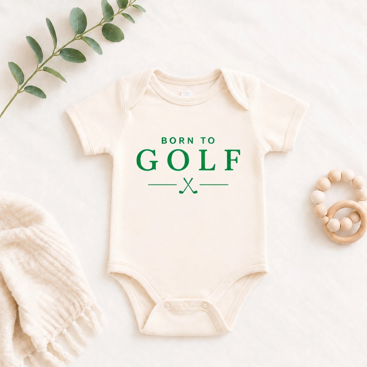 Cream baby bodysuit featuring Born to Golf graphic