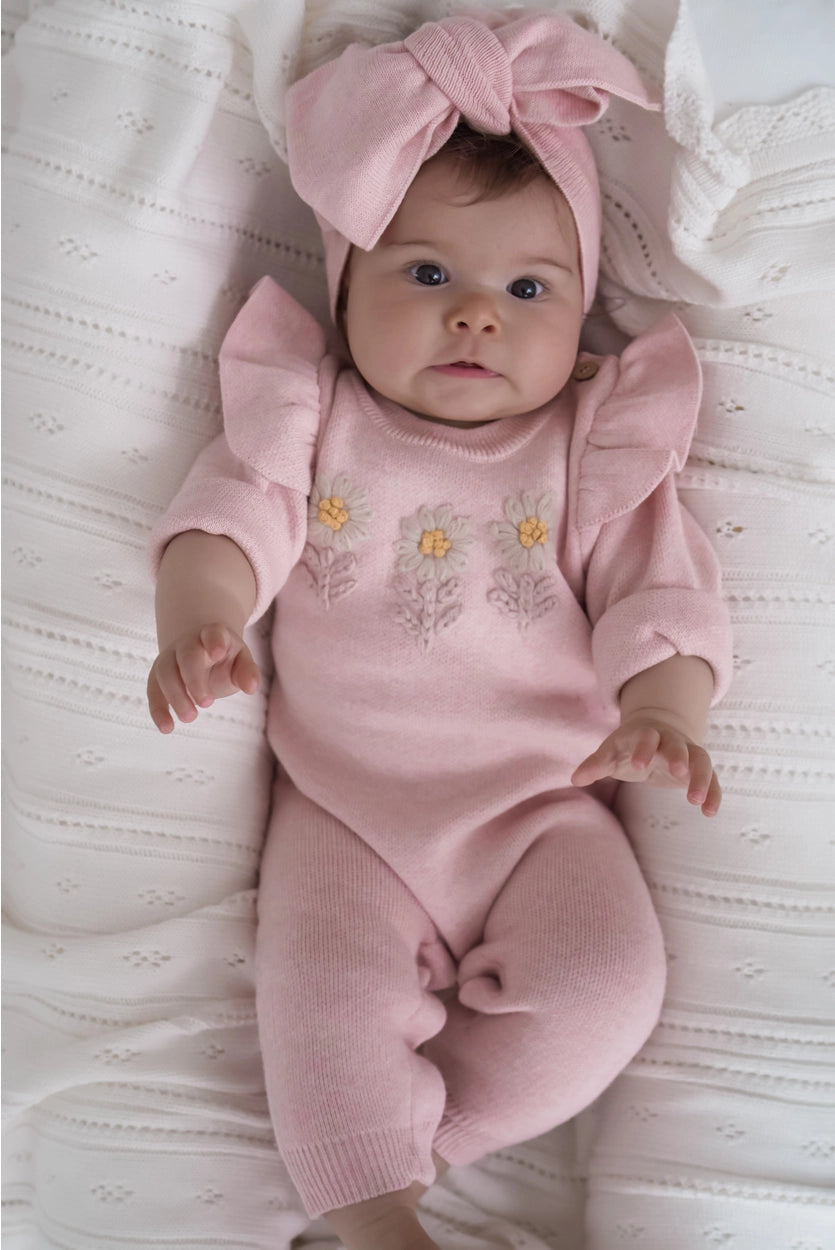 Soft pink organic baby romper with embroidered flowers