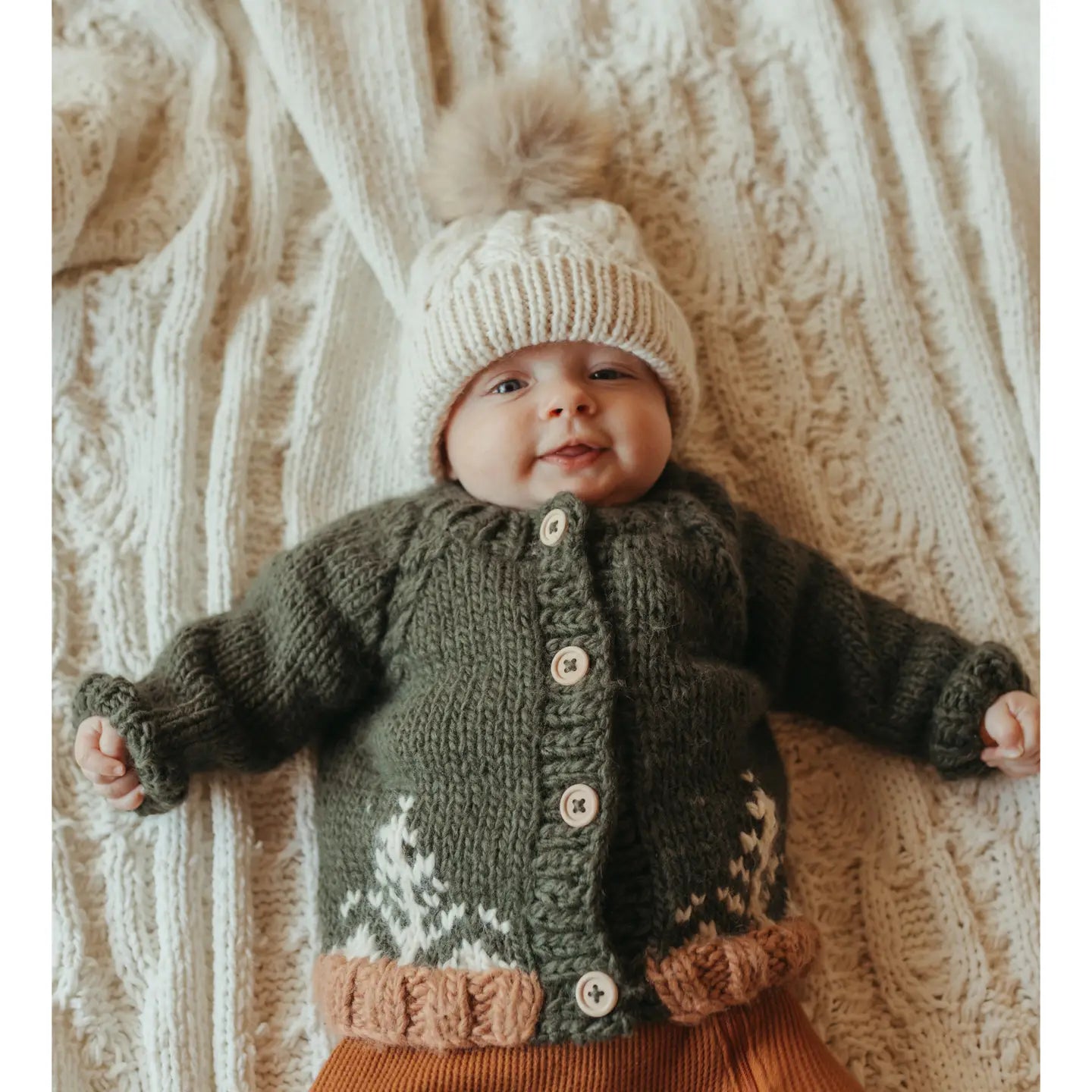 Warm winter baby sweater in deep brown wool blend with tree motif and natural button closure