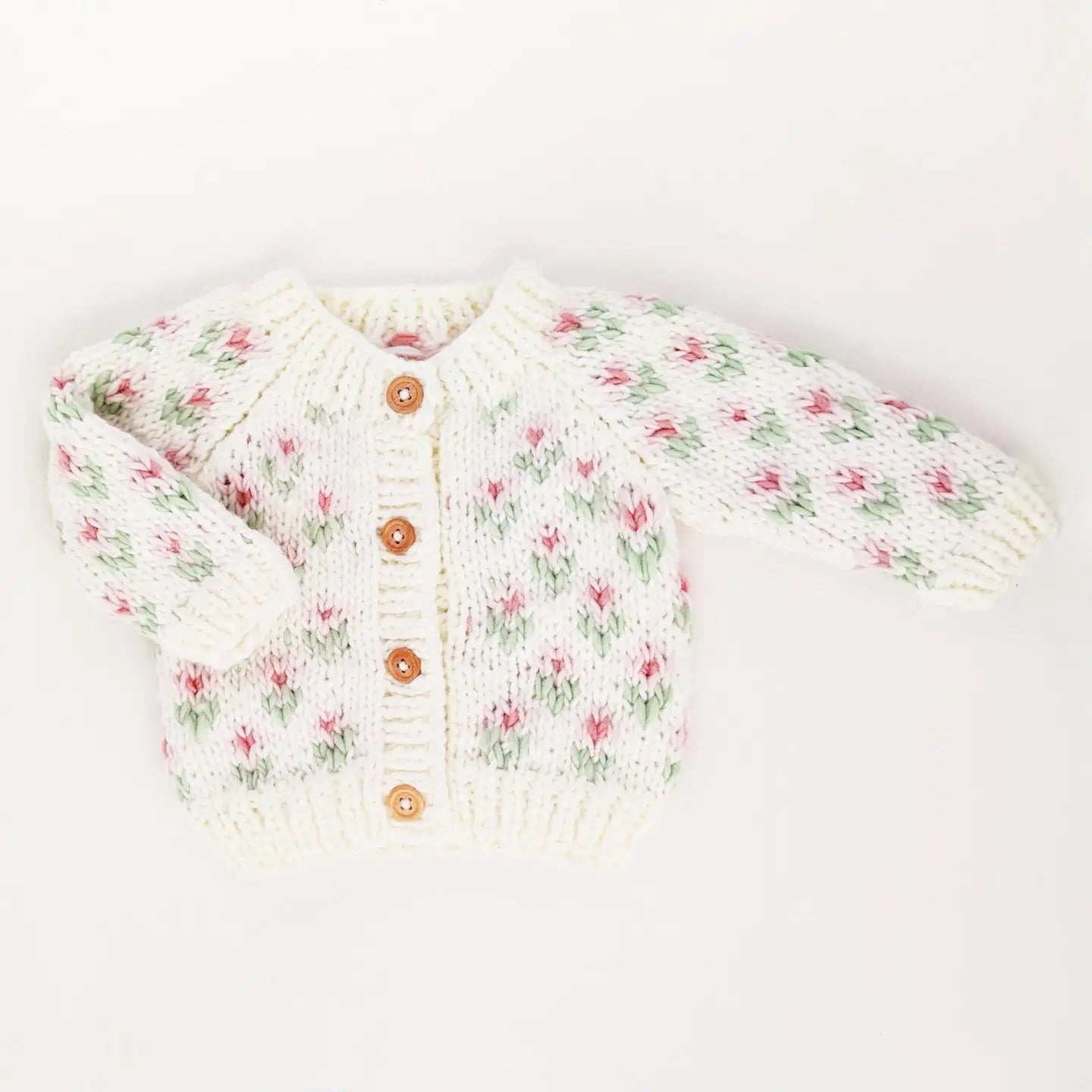 Floral patterned baby cardigan on a white background