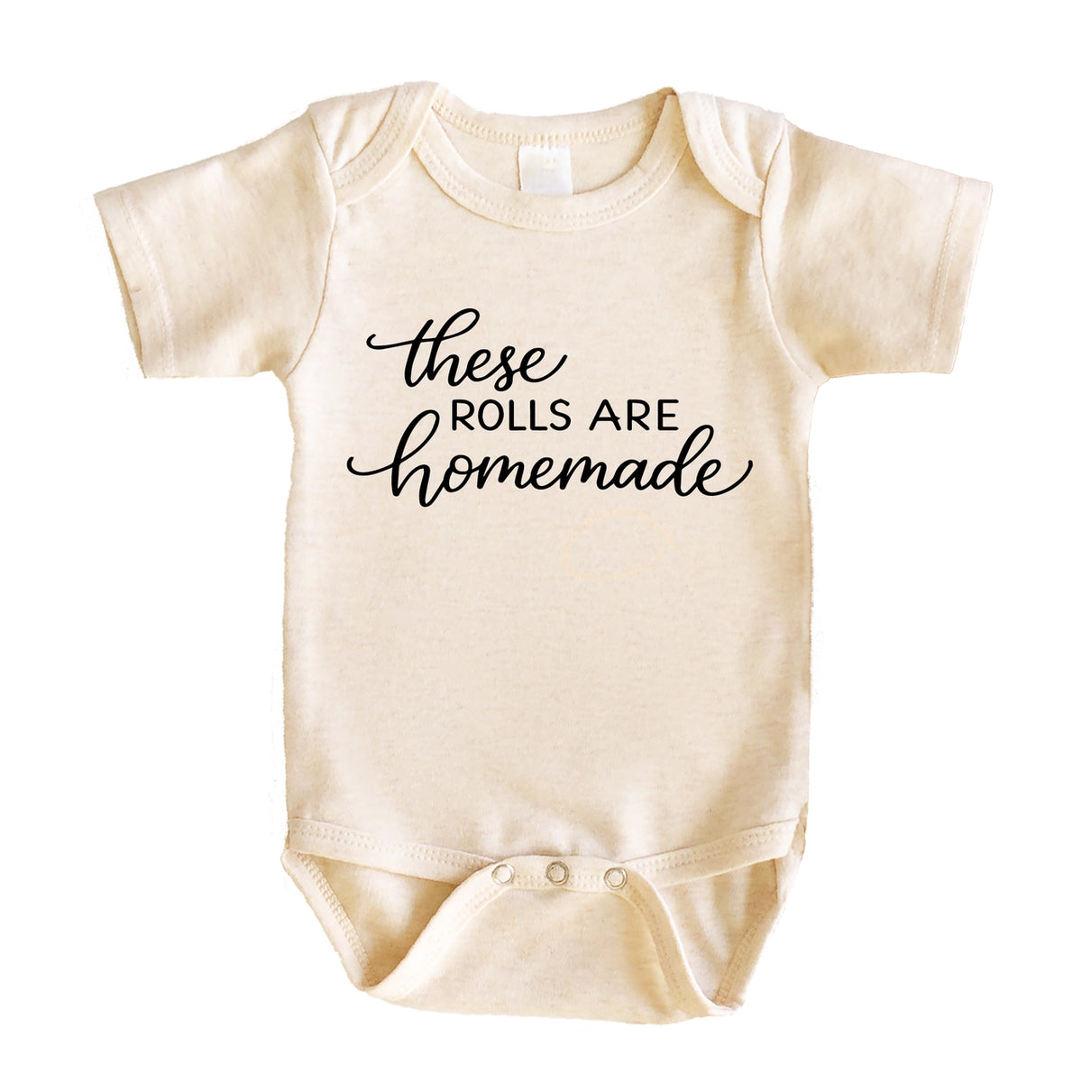 Cream baby bodysuit with black “These Rolls Are Homemade” lettering and short sleeves.