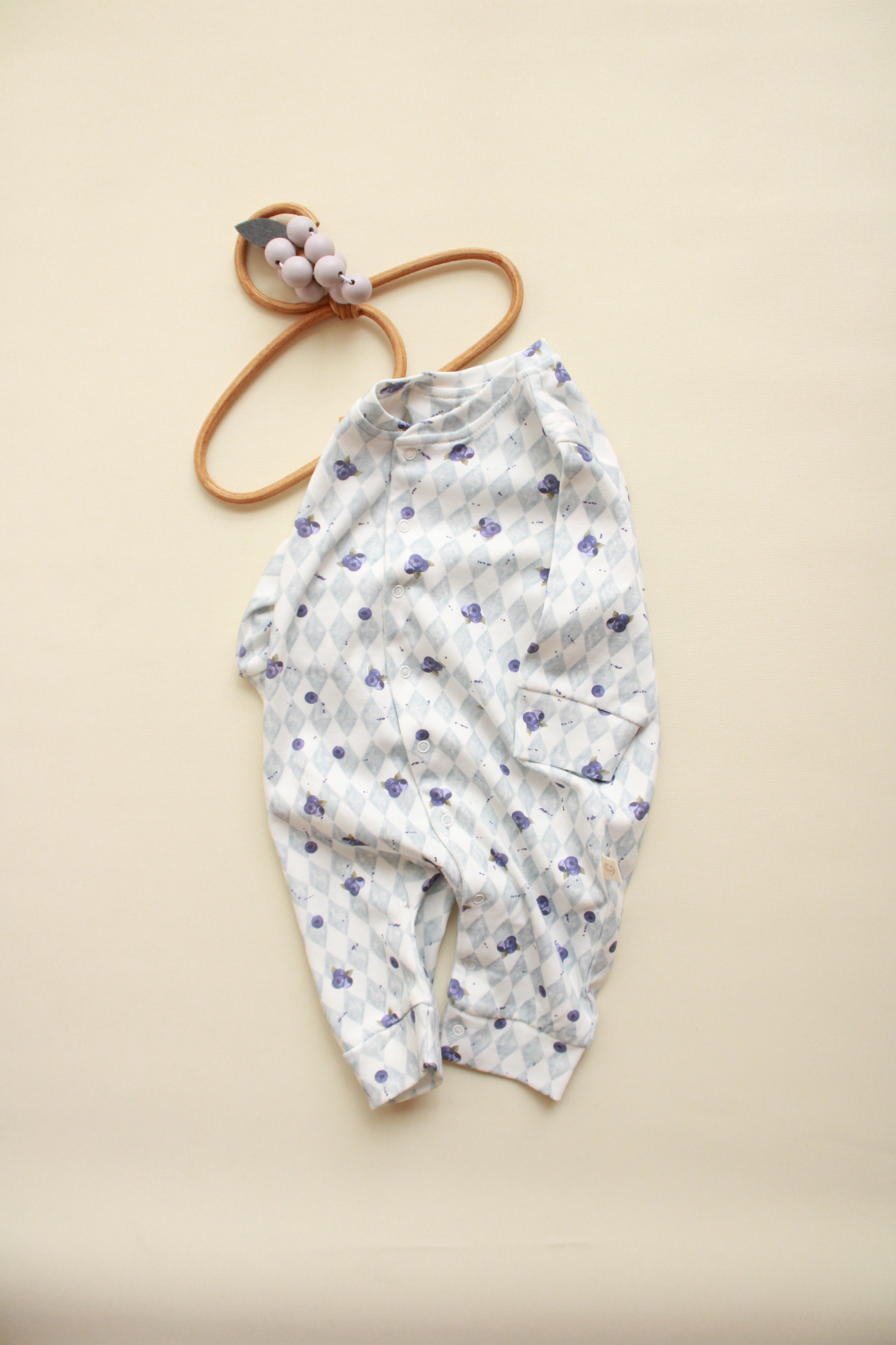 Soft cotton baby jumpsuit with long sleeves and snap buttons