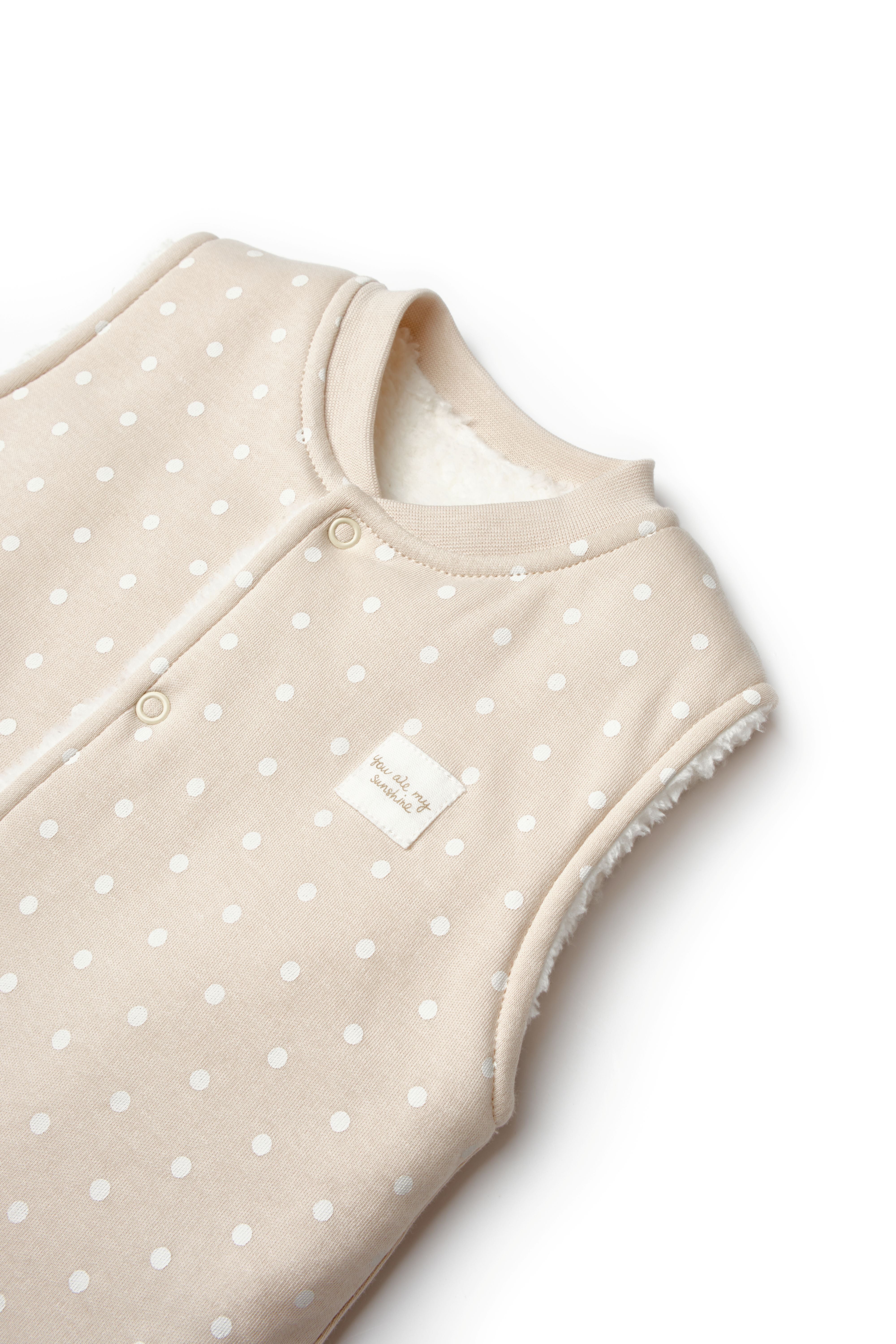 Neutral polka dot sleeveless baby vest with snap buttons
