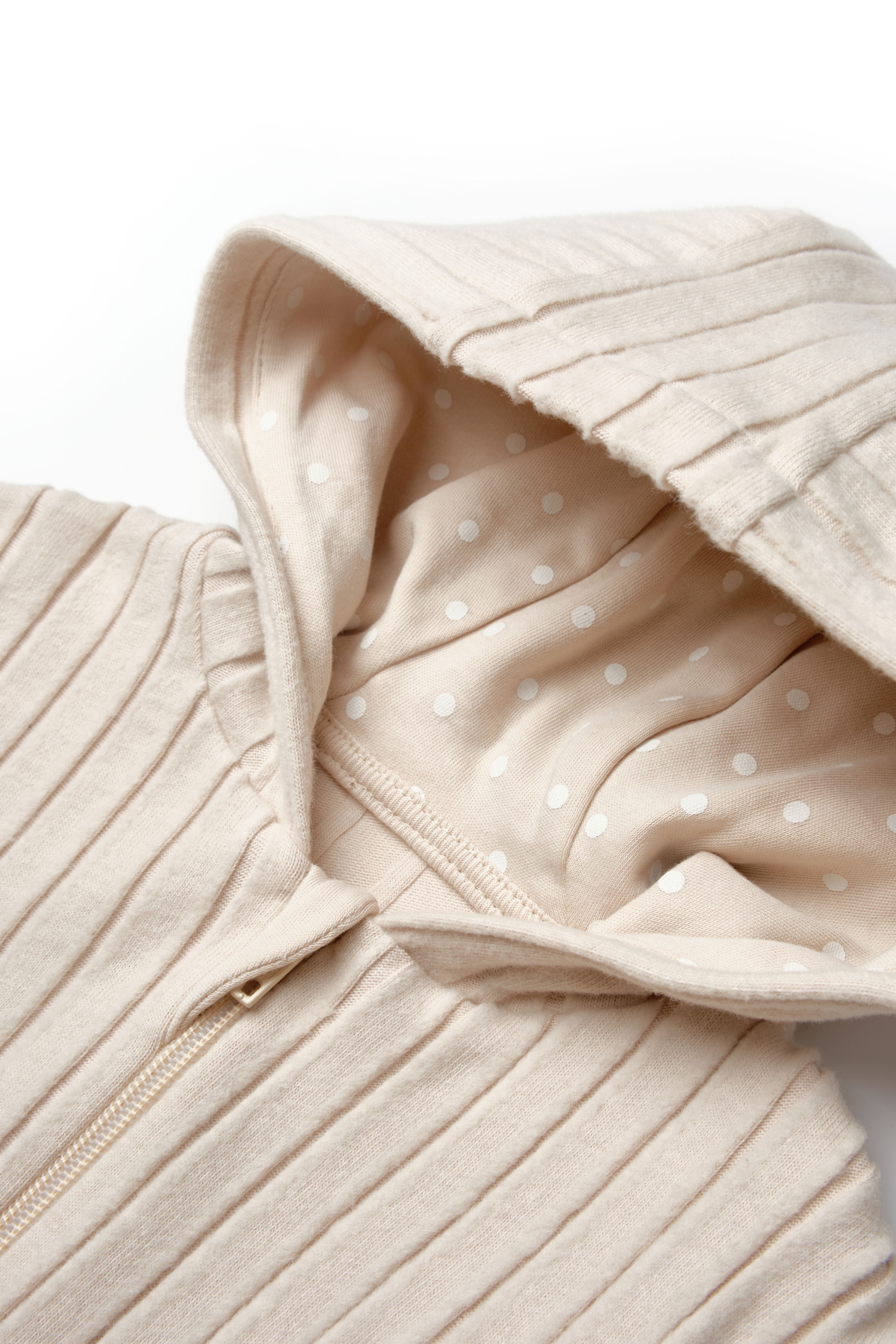 Organic zip-up baby jacket with polka dot interior hood lining