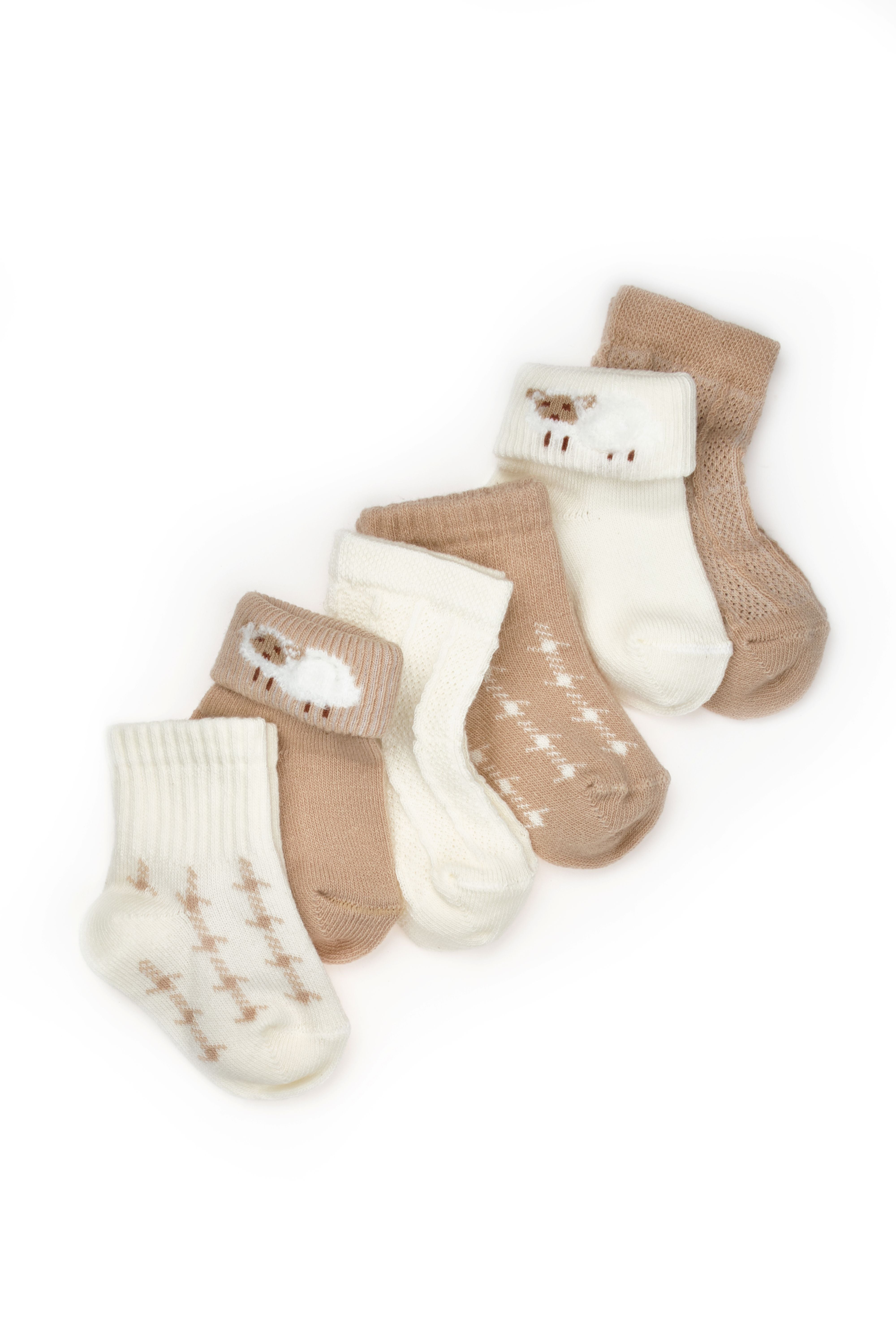 Organic newborn clothing collection in cream and beige tones