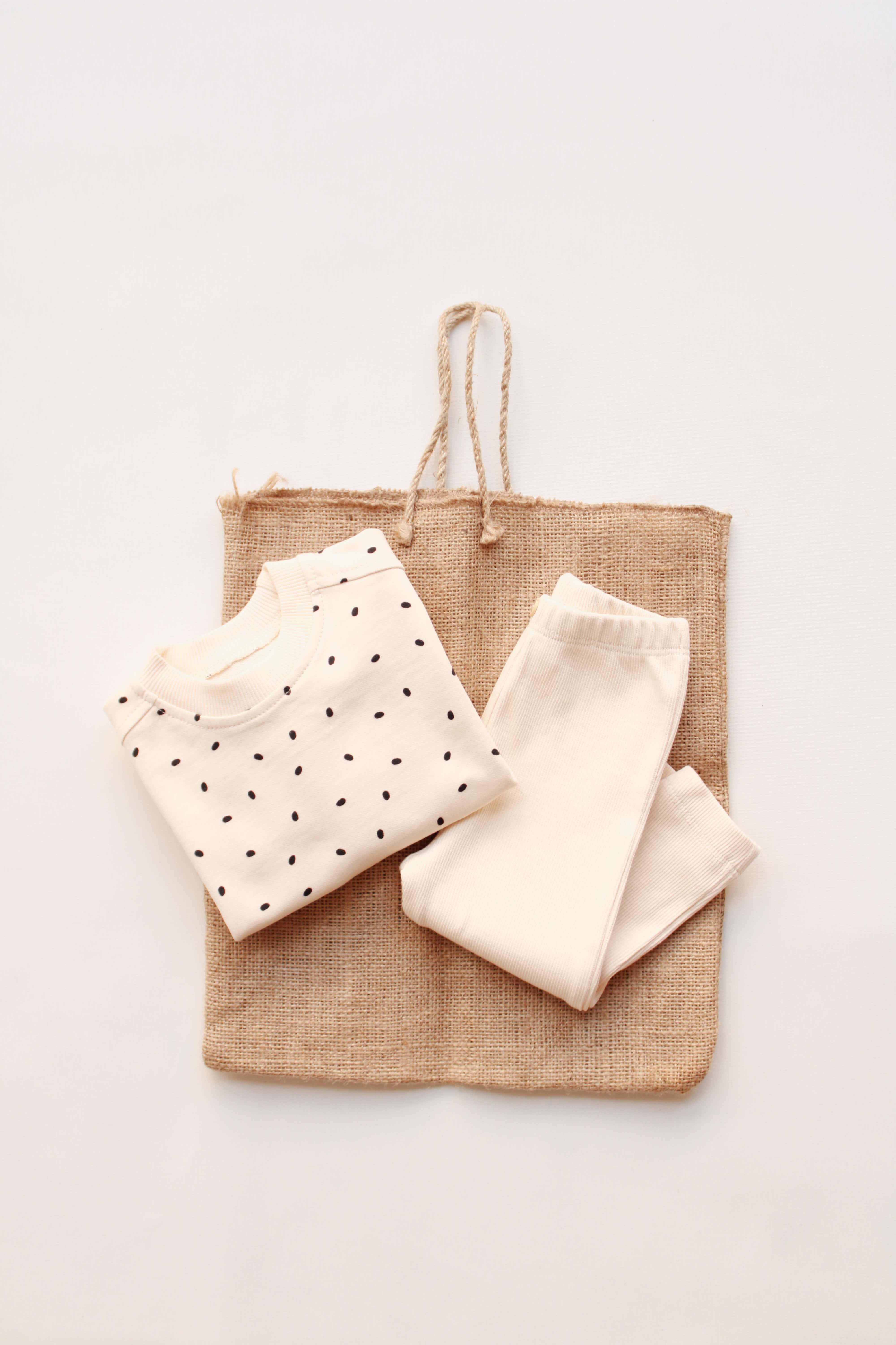 Minimalist beige cotton baby set featuring long-sleeve top and pants.