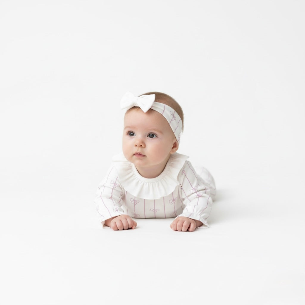 Organic cotton newborn romper set with matching lilac headband.