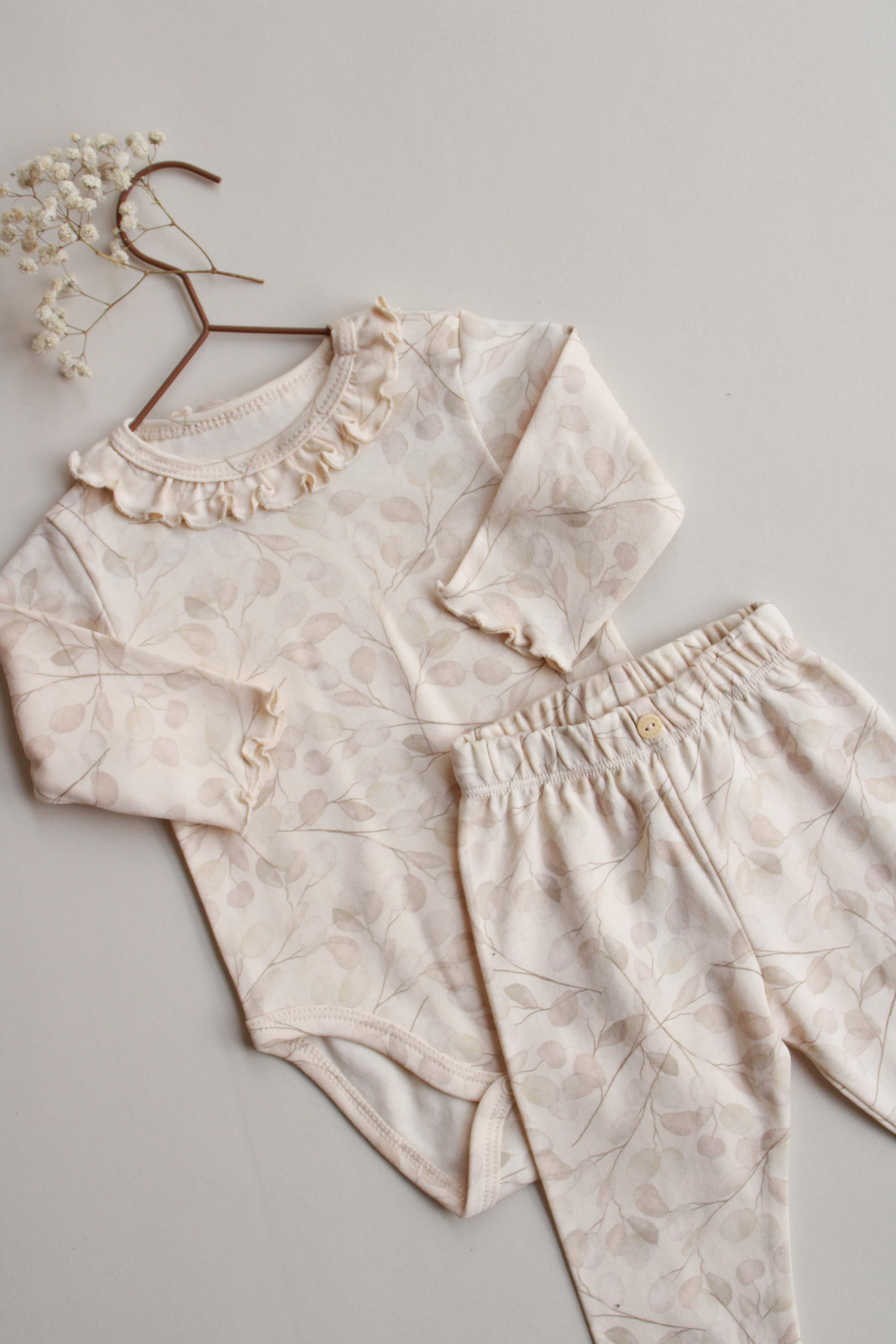 soft pastel botanical baby outfit with ruffle neckline
